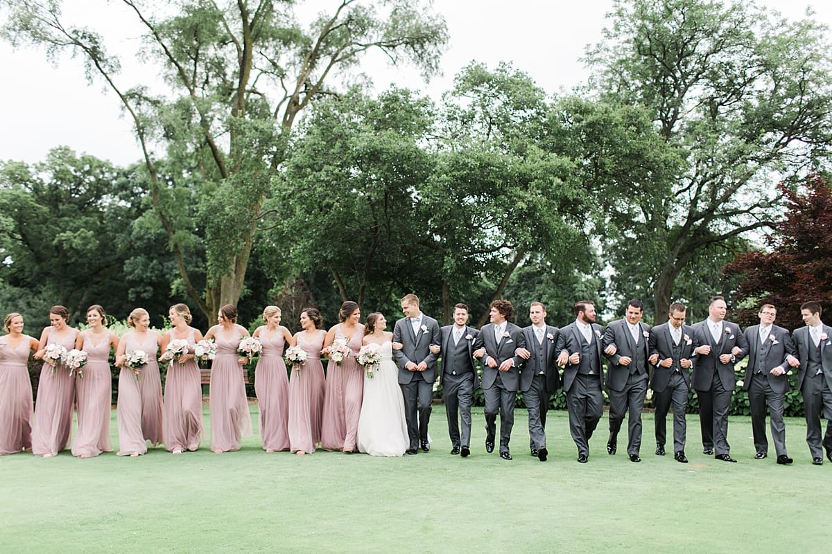 Arielle Peters Photography | Wedding party walking on golf course on wedding day at Morris Park Country Club in South Bend, Indiana.