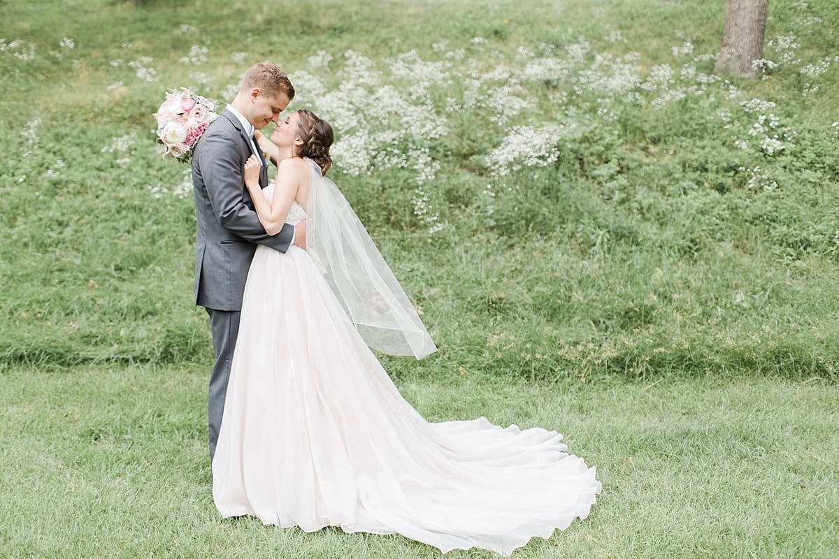 Arielle Peters Photography | Bride and groom almost kissing on golf course on wedding day at Morris Park Country Club in South Bend, Indiana.