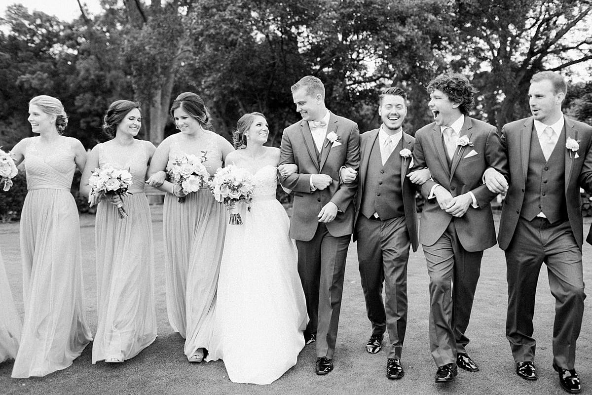 Arielle Peters Photography | Wedding party walking on golf course on wedding day at Morris Park Country Club in South Bend, Indiana.