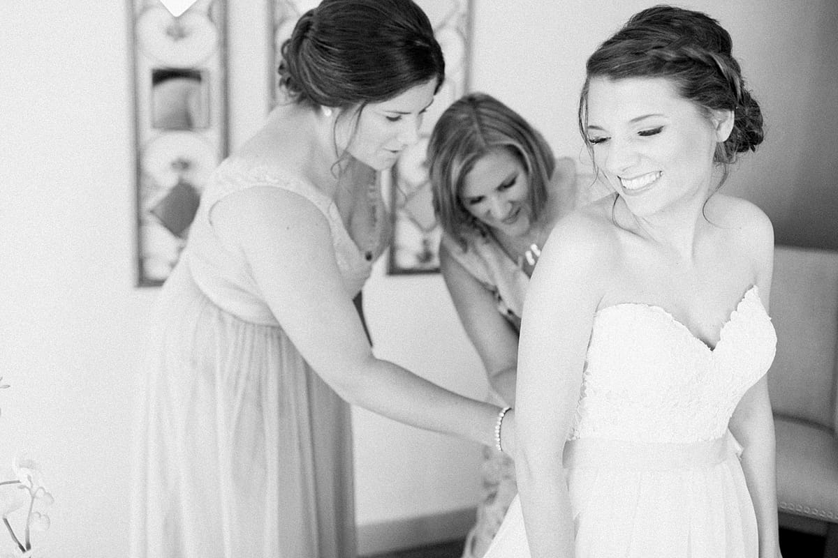Arielle Peters Photography | Bride putting on dress on wedding day at Morris Park Country Club in South Bend, Indiana.