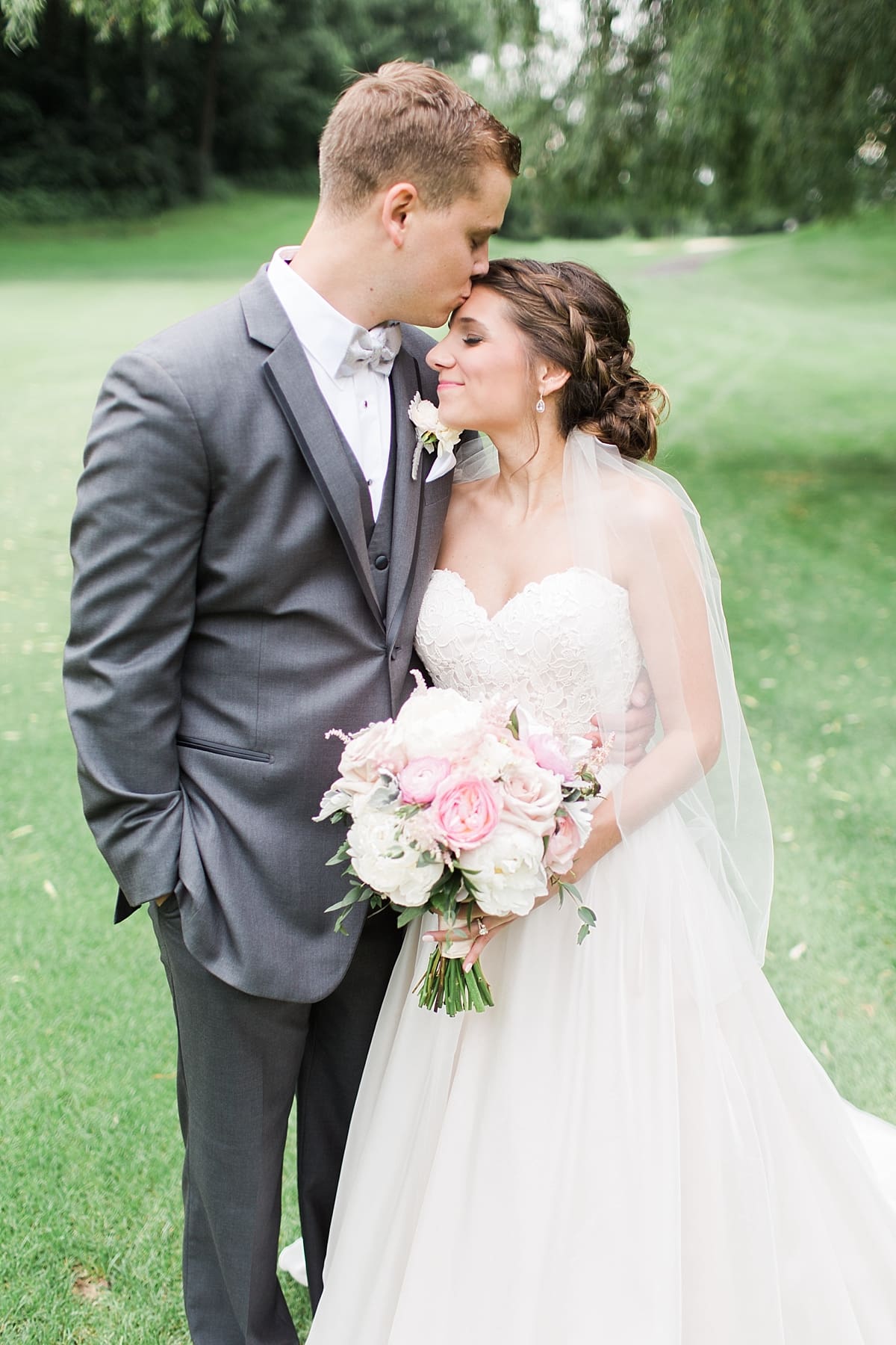 Arielle Peters Photography | Groom kissing bride's forehead on wedding day at Morris Park Country Club in South Bend, Indiana.