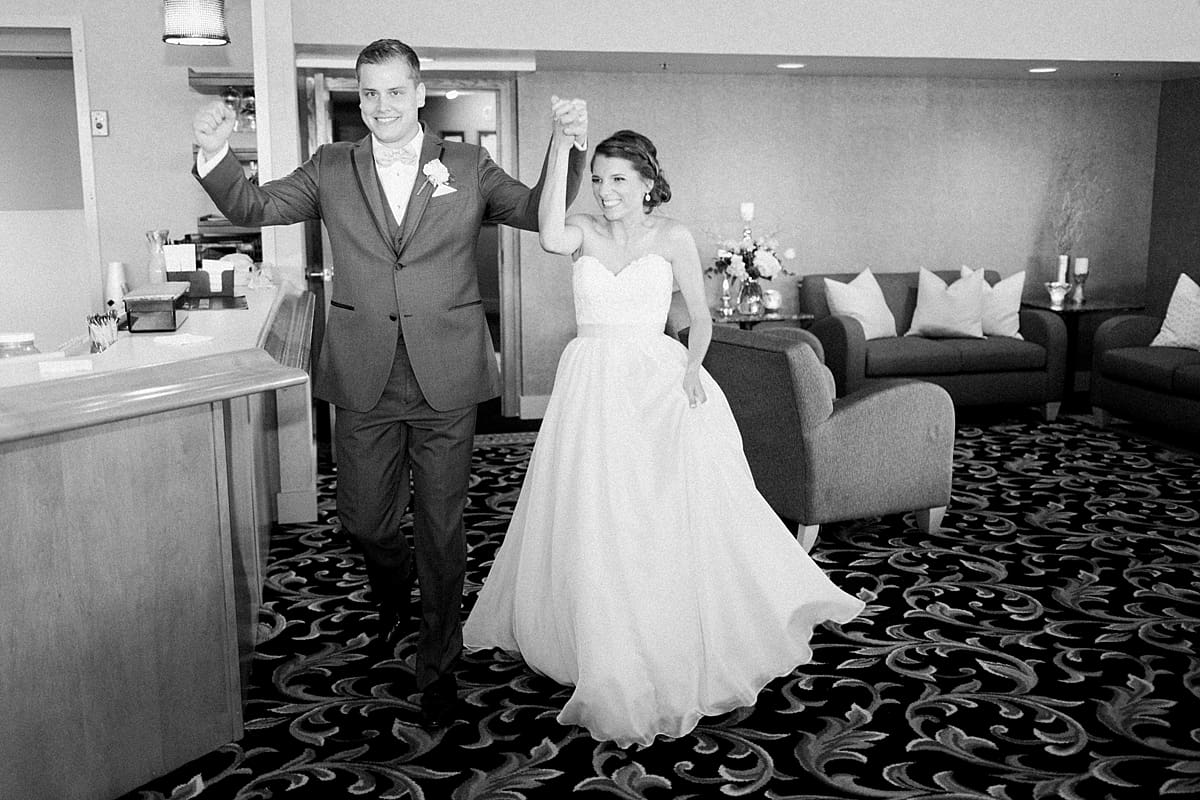 Arielle Peters Photography | Bride and groom entering wedding reception on wedding day at Morris Park Country Club in South Bend, Indiana.