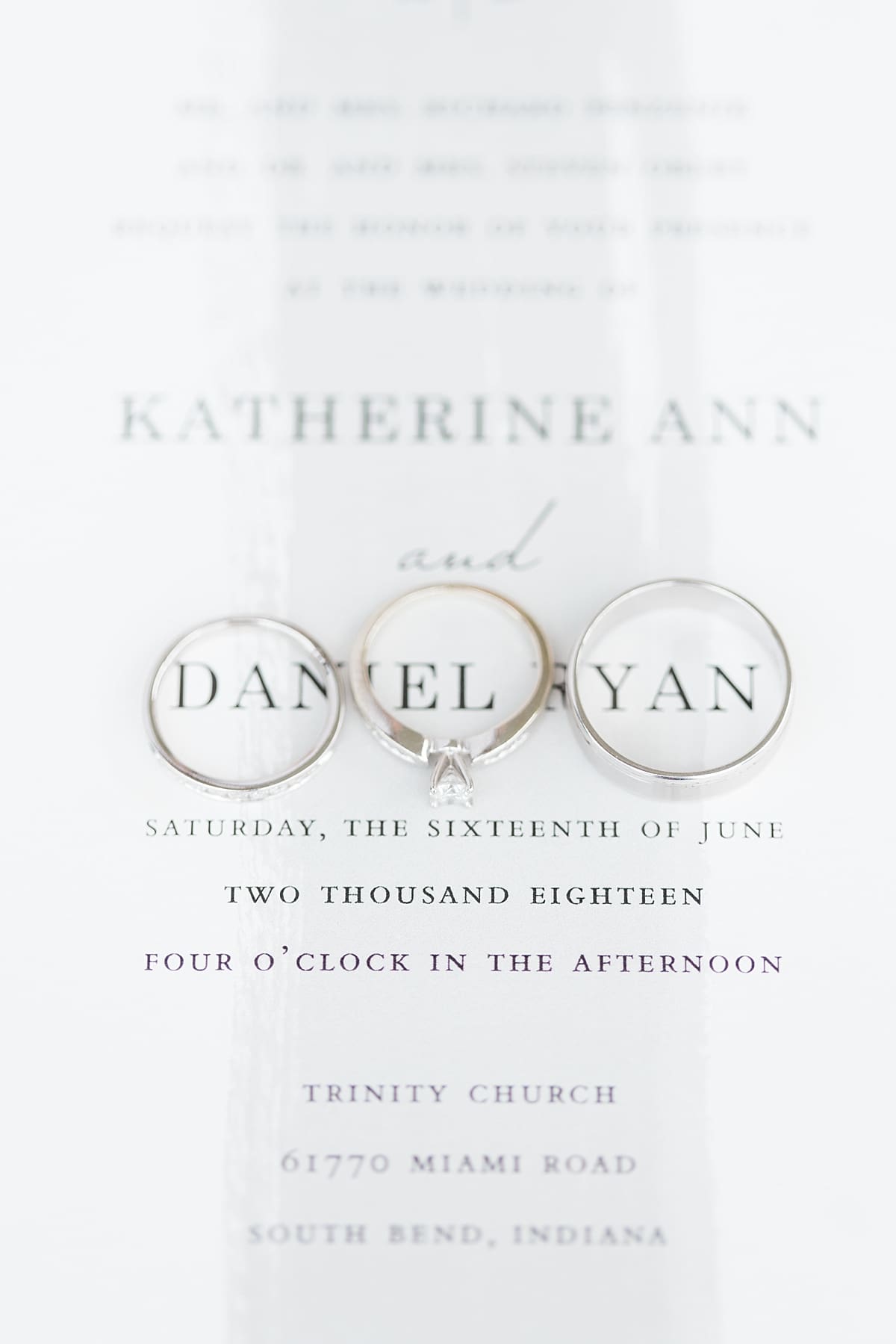 Arielle Peters Photography | Wedding rings lined on wedding invitation on wedding day at Trinity Church in South Bend, Indiana.