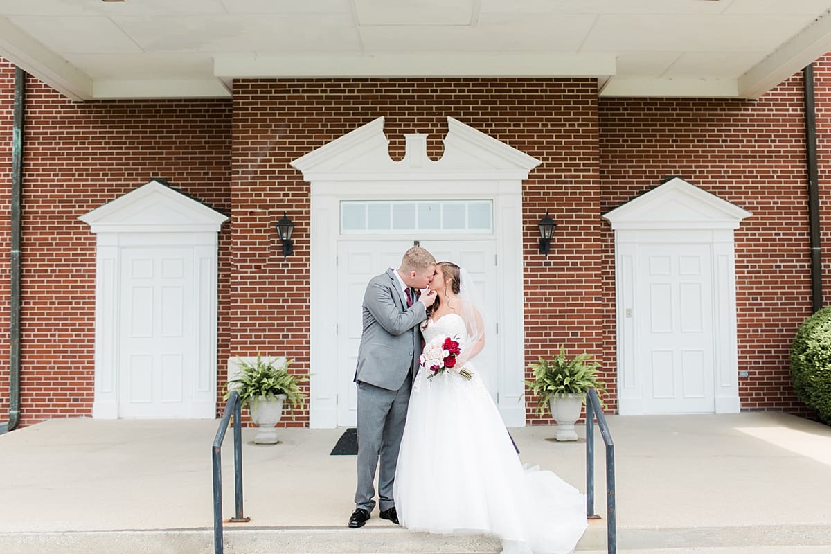 Arielle Peters Photography | Bride and groom outside brick church on wedding day at Trinity Church in South Bend, Indiana.