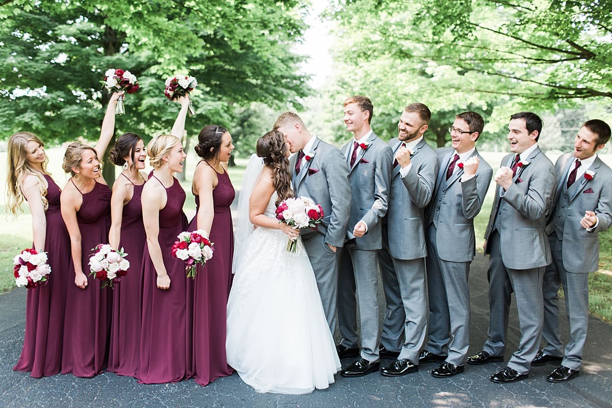 Arielle Peters Photography | Wedding party cheering on empty street on wedding day at Trinity Church in South Bend, Indiana.
