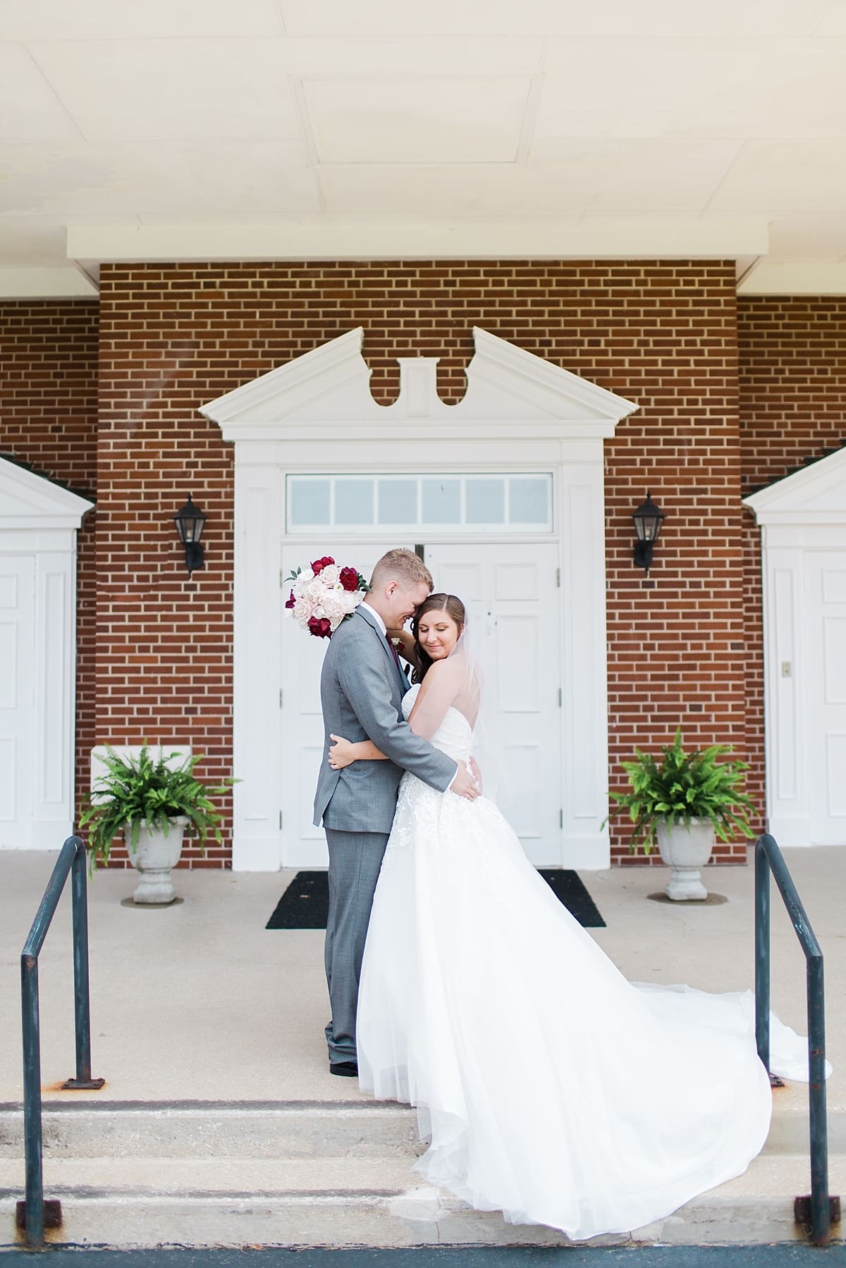Arielle Peters Photography | Bride and groom outside brick church on wedding day at Trinity Church in South Bend, Indiana.