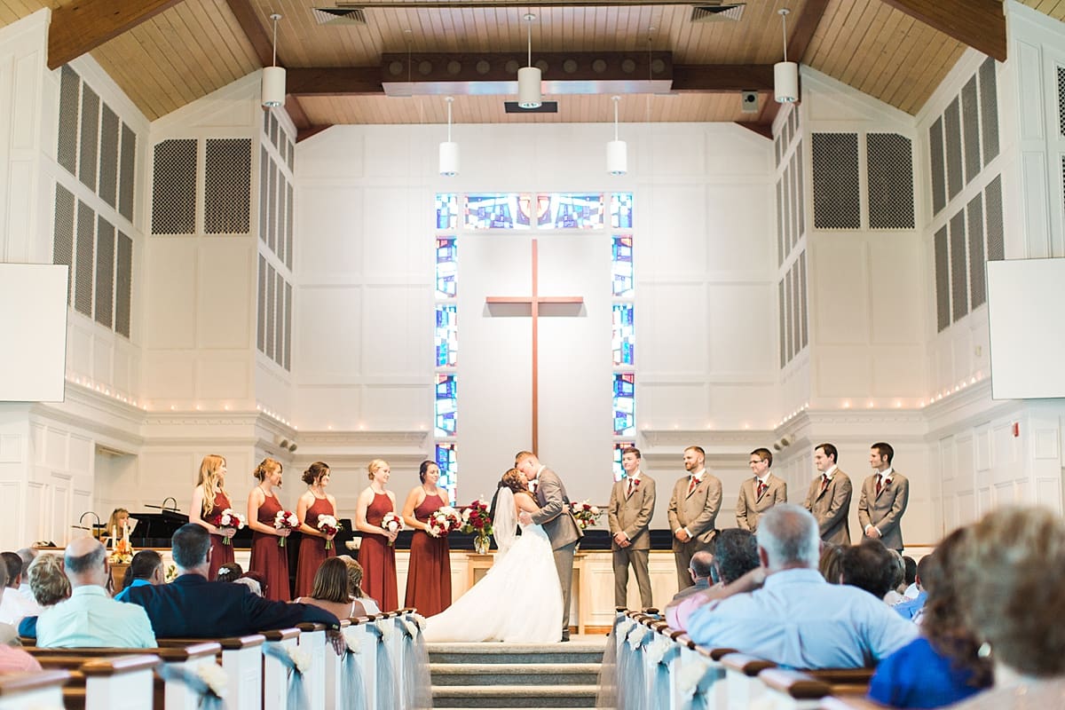 Arielle Peters Photography | Bride and groom kissing at the alter on wedding day at Trinity Church in South Bend, Indiana.