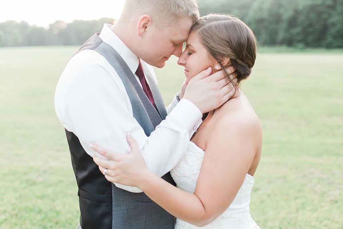 Arielle Peters Photography | Bride and groom almost kissing in open field on wedding day at Sts. Peter and Paul Social Hall in South Bend, Indiana.