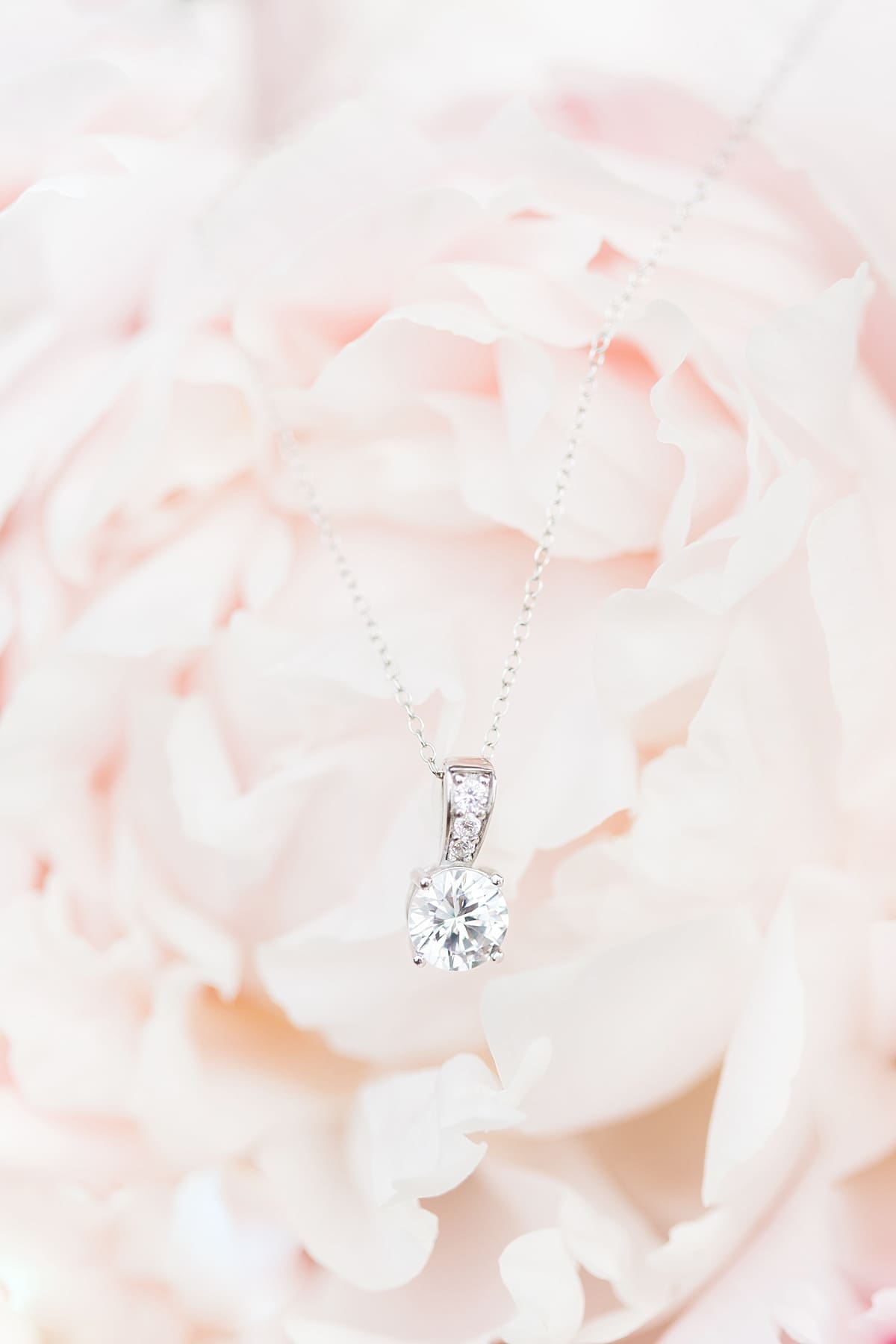 Arielle Peters Photography | Bride's jewelry hanging on peony on wedding day at Trinity Church in South Bend, Indiana.