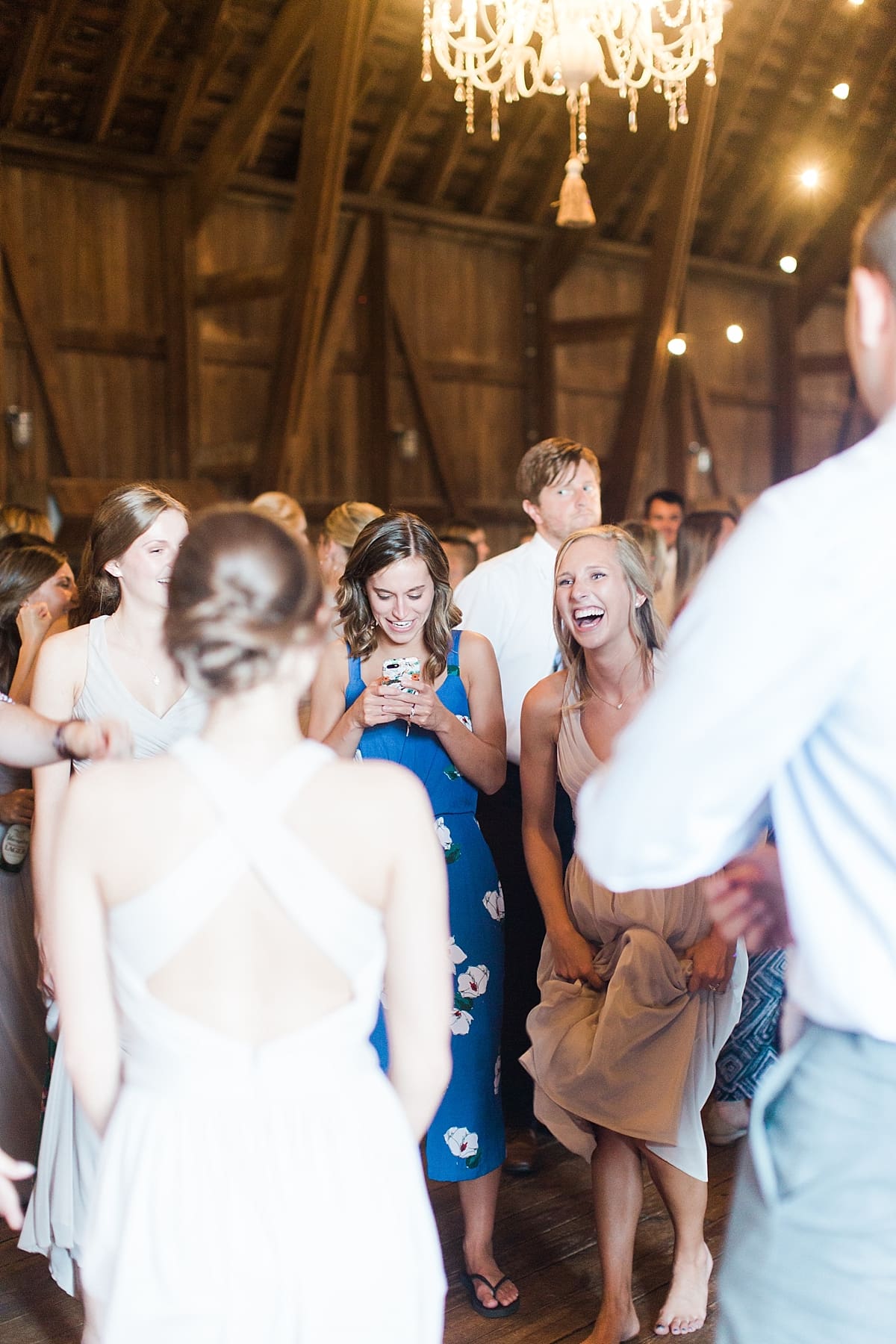 Arielle Peters Photography | Wedding guests dancing inside historic barn on wedding day at St. Joe Farm in Granger, Indiana.
