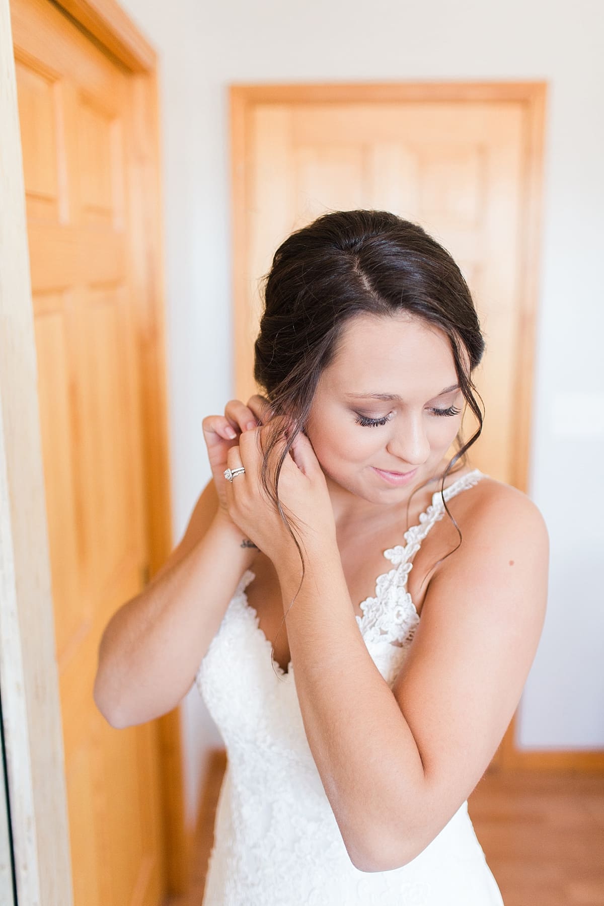 Arielle Peters Photography | Bride putting on wedding jewerly on wedding day at St. Joe Farm in Granger, Indiana.