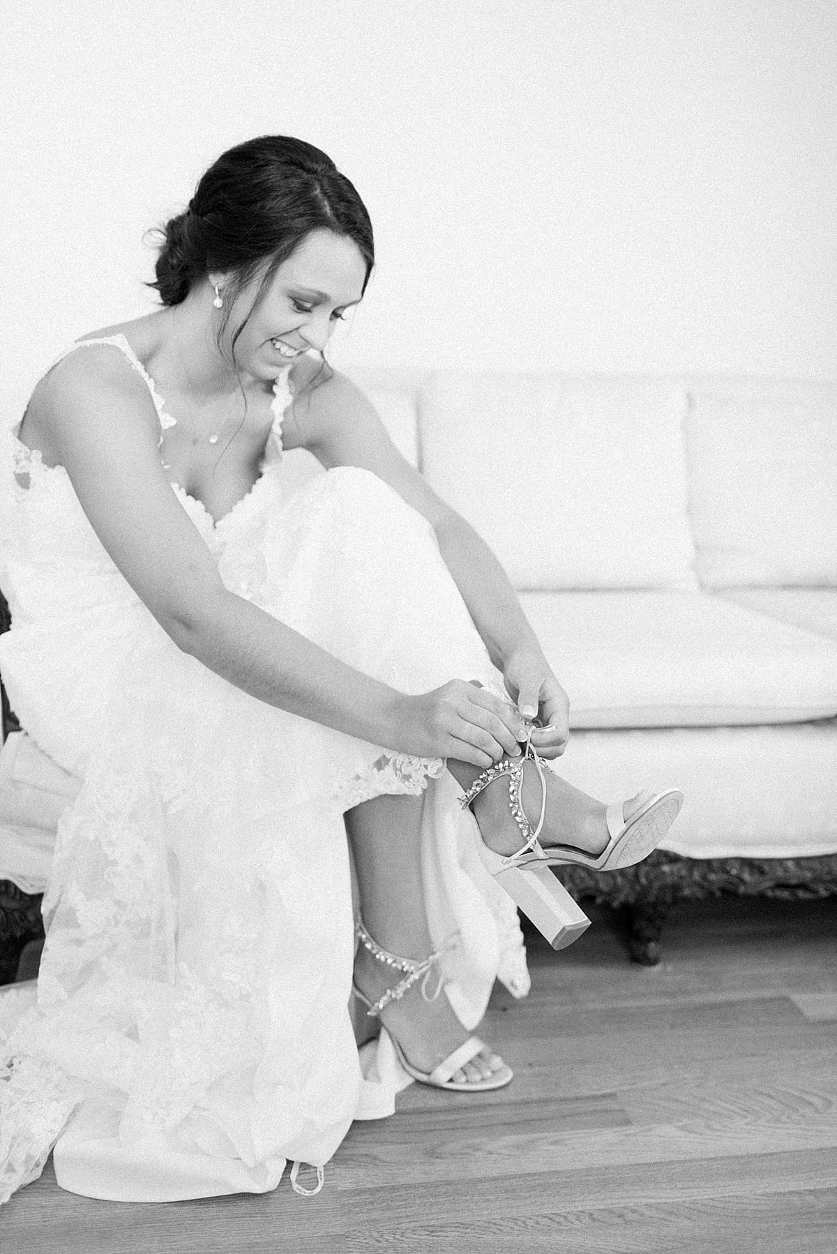Arielle Peters Photography | Bride putting on wedding day shoes on wedding day at St. Joe Farm in Granger, Indiana.