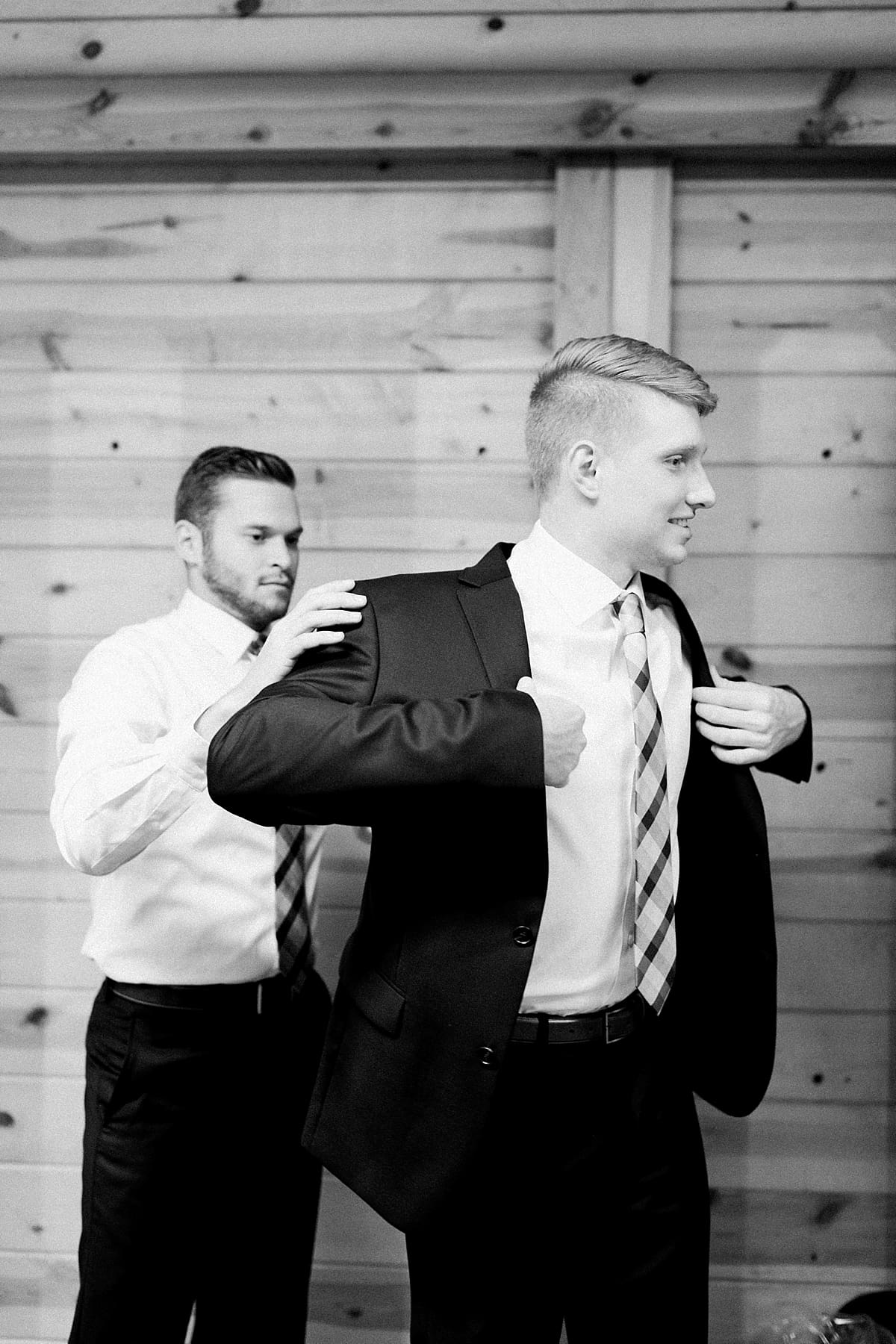 Arielle Peters Photography | Groom putting on tux jacket on wedding day at St. Joe Farm in Granger, Indiana.
