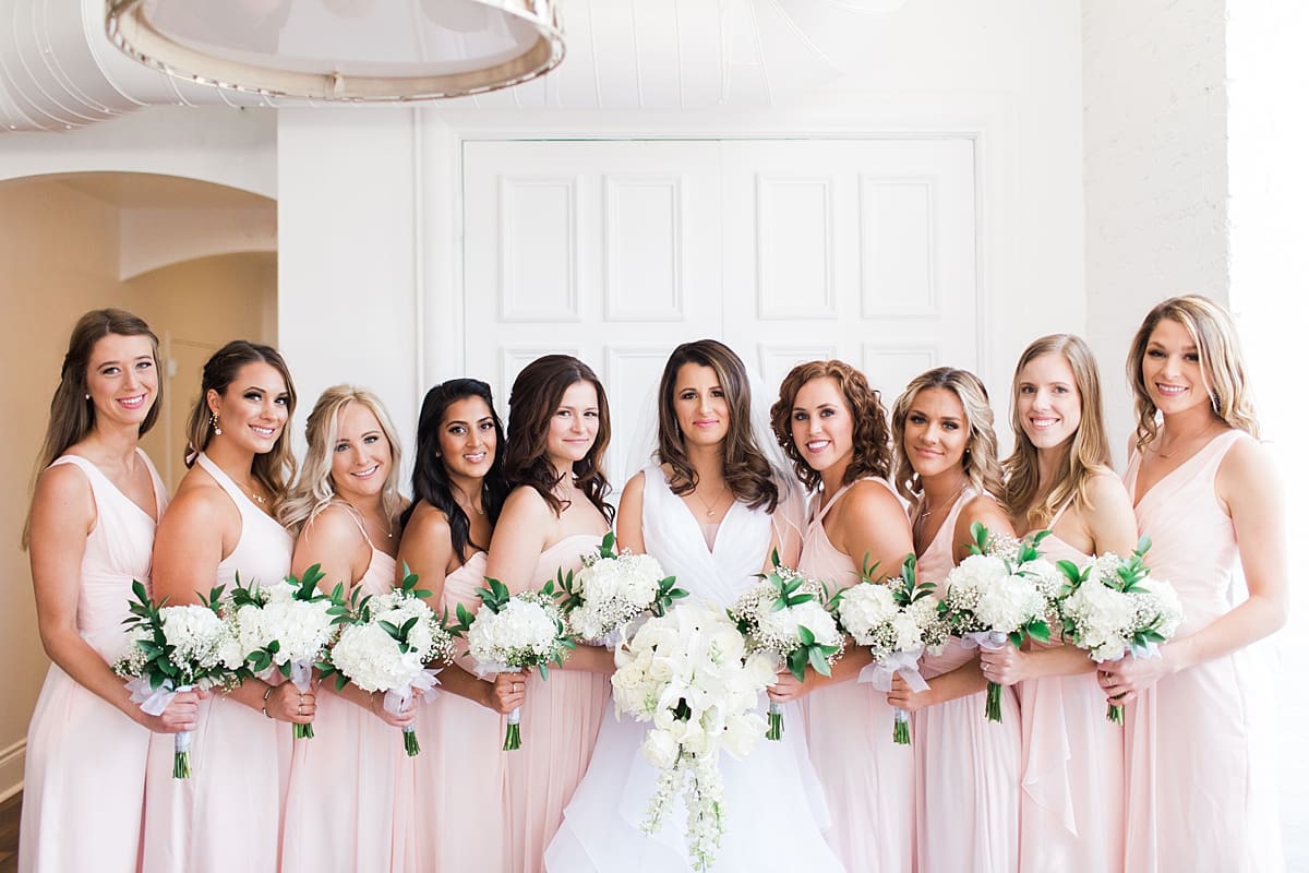 Arielle Peters Photography | Bride and bridesmaids with bouquets on wedding day at Loft 310 in Kalamazoo, Michigan.