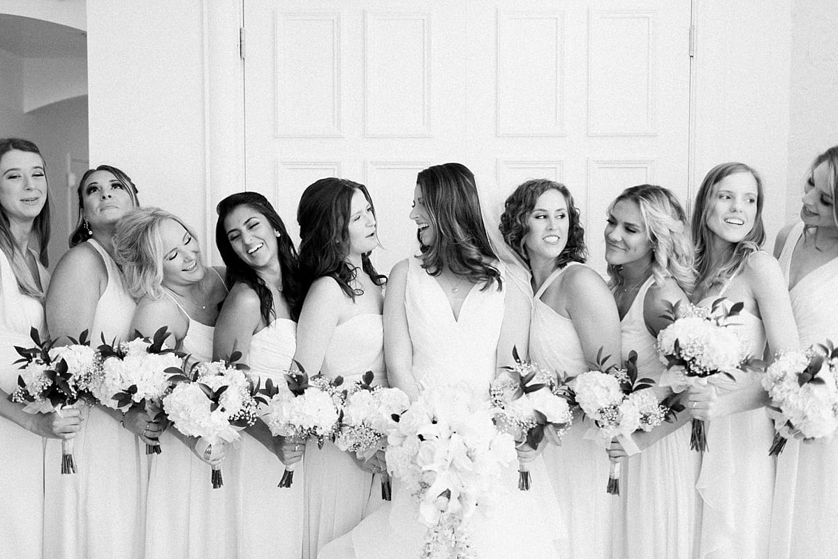Arielle Peters Photography | Bride and bridesmaids with bouquets on wedding day at Loft 310 in Kalamazoo, Michigan.
