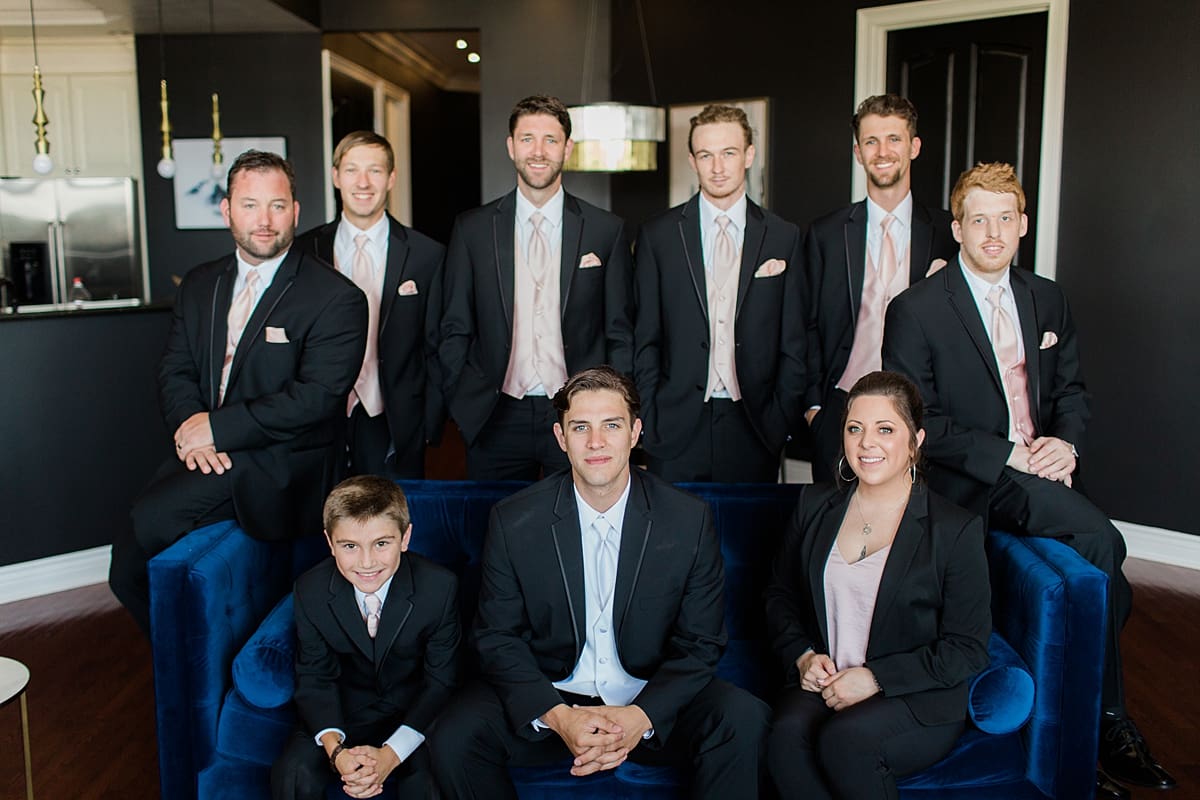 Arielle Peters Photography | Groom and groomsmen on velvet couch on wedding day at Loft 310 in Kalamazoo, Michigan.
