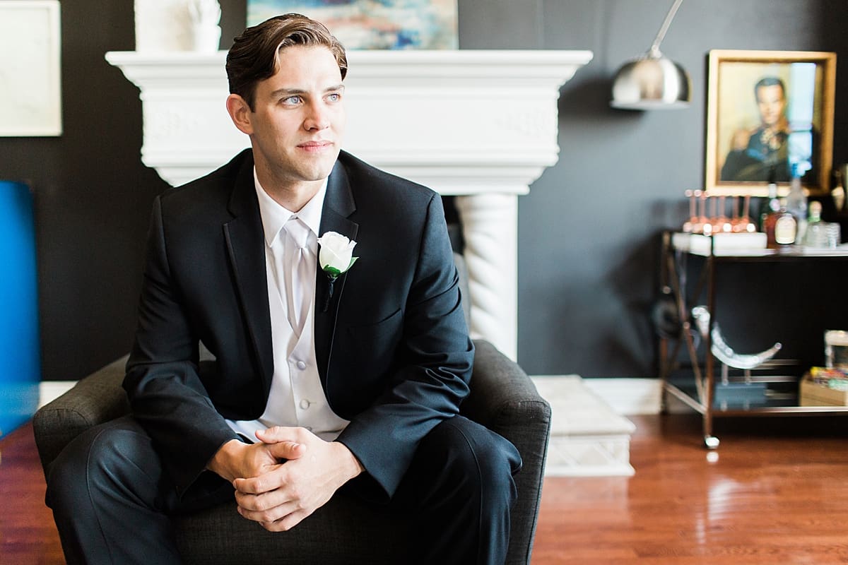 Groom sitting in his tux on wedding day at Loft 310 in Kalamazoo, Michigan.