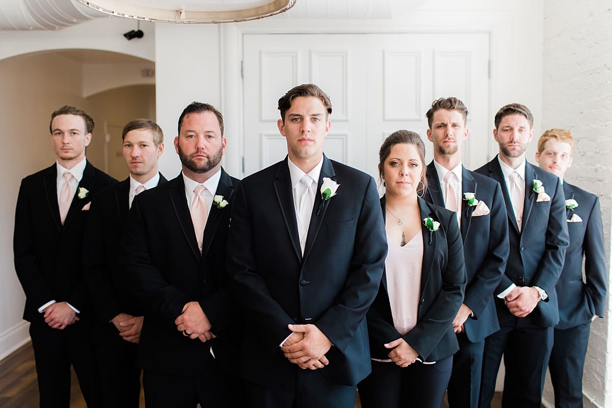 Arielle Peters Photography | Groom and groomsmen with serious faces on wedding day at Loft 310 in Kalamazoo, Michigan.