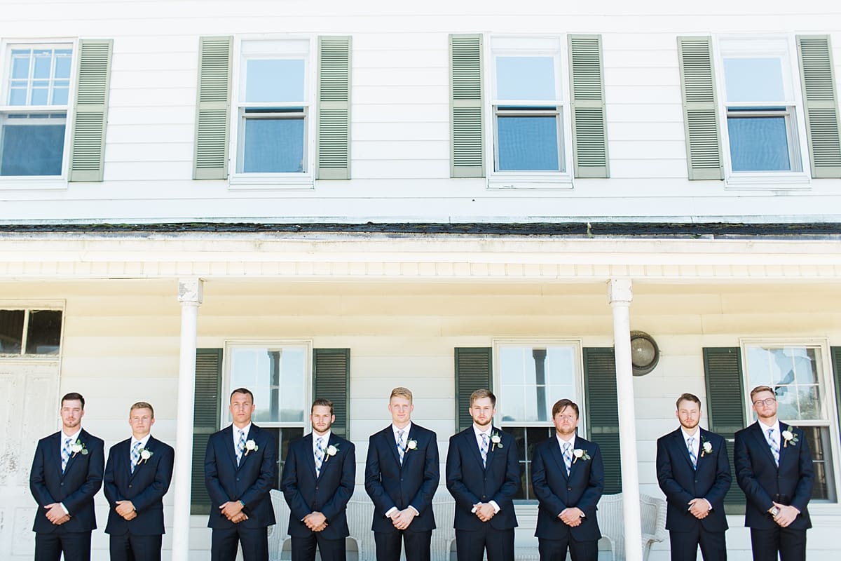 Arielle Peters Photography | Groom and groomsmen on front porch on wedding day at St. Joe Farm in Granger, Indiana.
