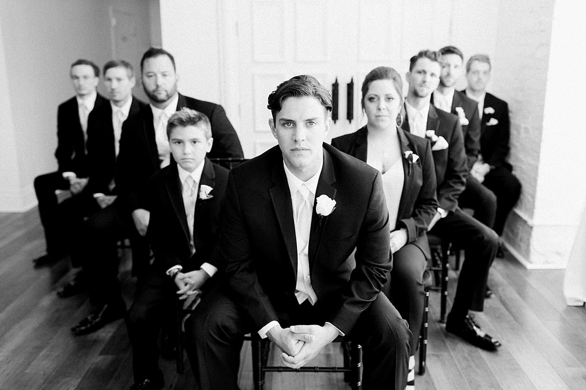 Arielle Peters Photography | Groom and groomsmen with serious faces on wedding day at Loft 310 in Kalamazoo, Michigan.