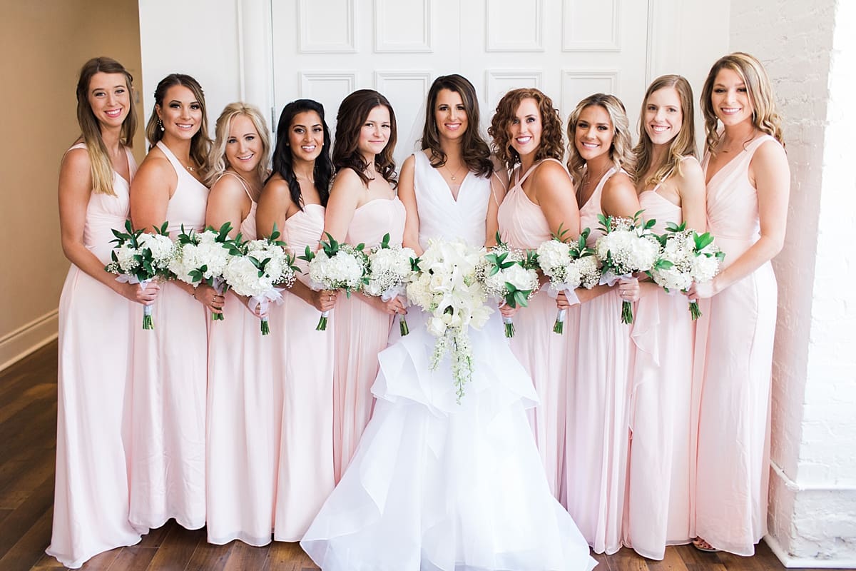 Arielle Peters Photography | Bride and bridesmaids with bouquets on wedding day at Loft 310 in Kalamazoo, Michigan.