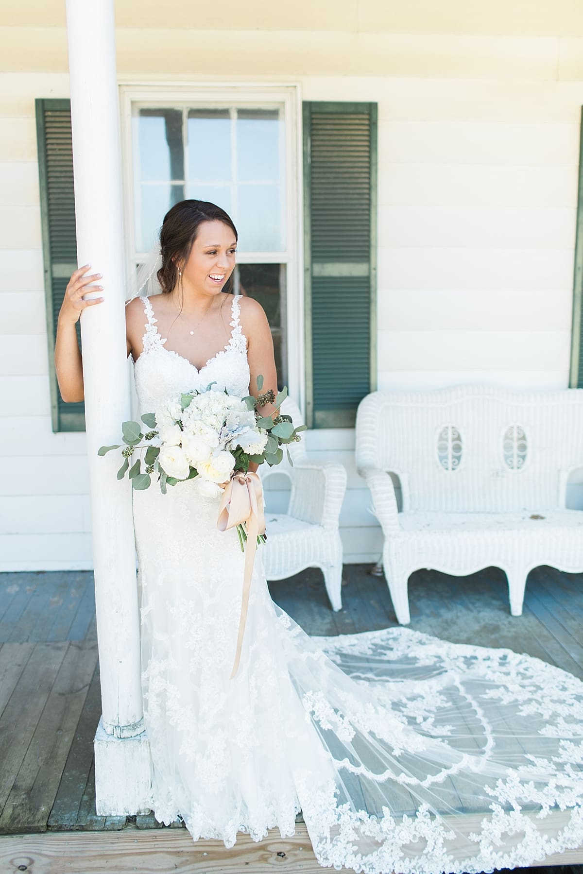 Arielle Peters Photography | Bride standing on front porch outside on wedding day at St. Joe Farm in Granger, Indiana.