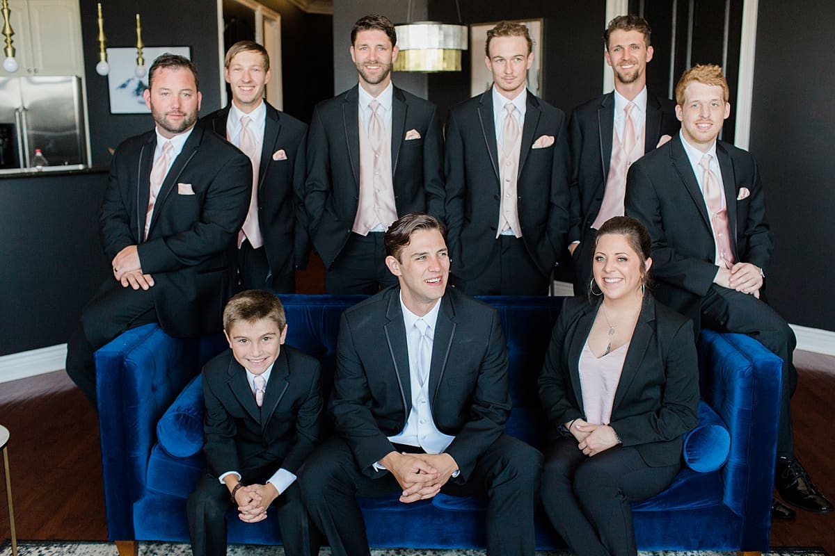 Arielle Peters Photography | Groom and groomsmen on velvet couch on wedding day at Loft 310 in Kalamazoo, Michigan.