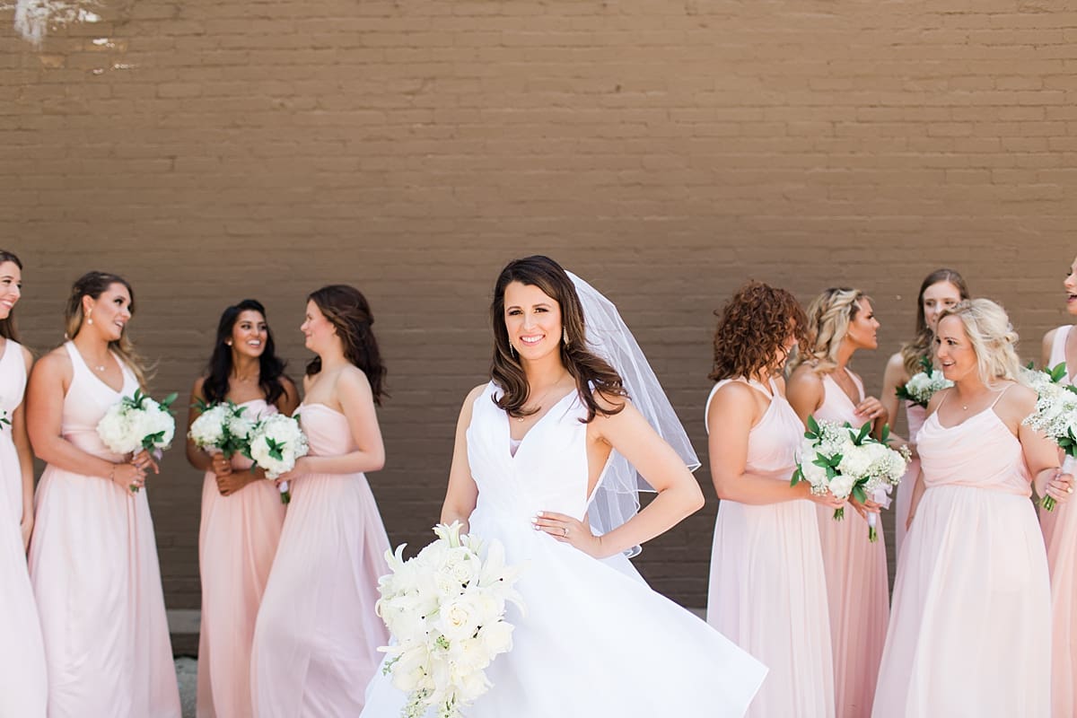 Arielle Peters Photography | Bride and bridesmaids with bouquets on wedding day at Loft 310 in Kalamazoo, Michigan.