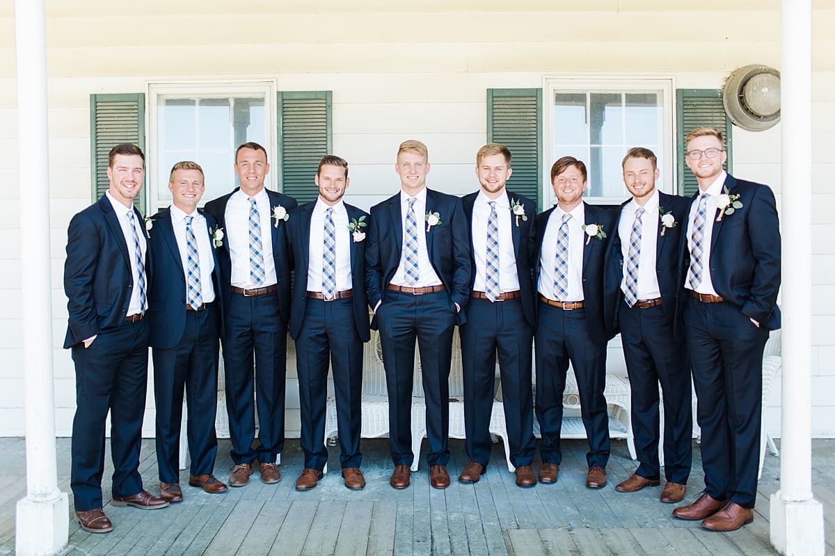 Arielle Peters Photography | Groom and groomsmen standing on front porch on wedding day at St. Joe Farm in Granger, Indiana.