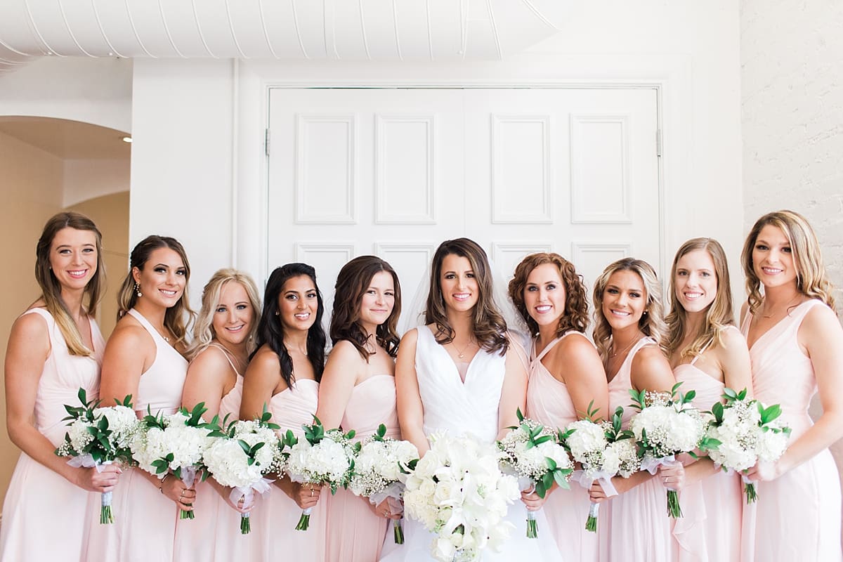 Arielle Peters Photography | Bride and bridesmaids with bouquets on wedding day at Loft 310 in Kalamazoo, Michigan.