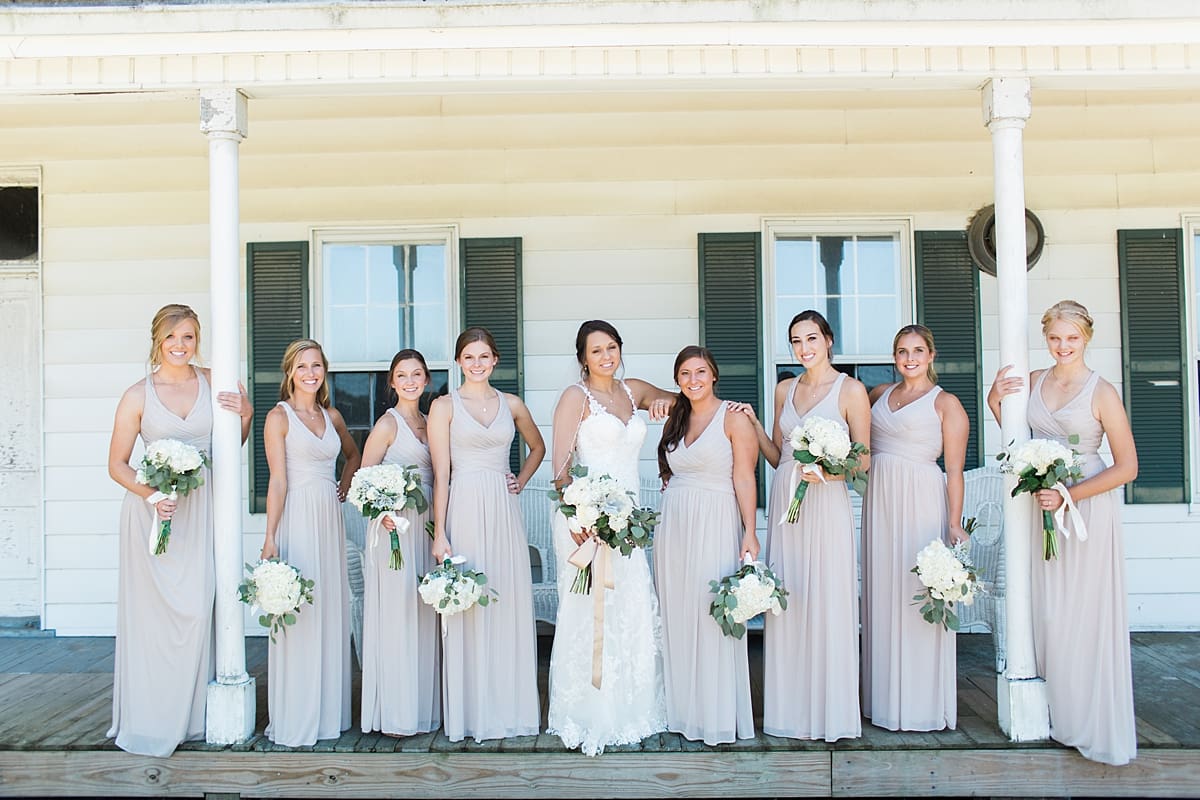 Arielle Peters Photography | Bride and bridesmaids standing on historic front porch on wedding day at St. Joe Farm in Granger, Indiana.