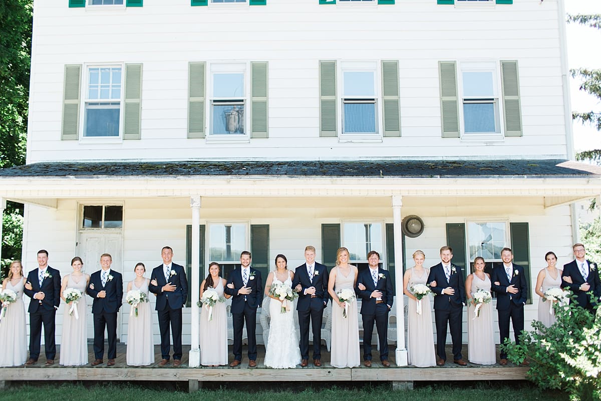 Arielle Peters Photography | Wedding party standing on historic front porch on wedding day at St. Joe Farm in Granger, Indiana.