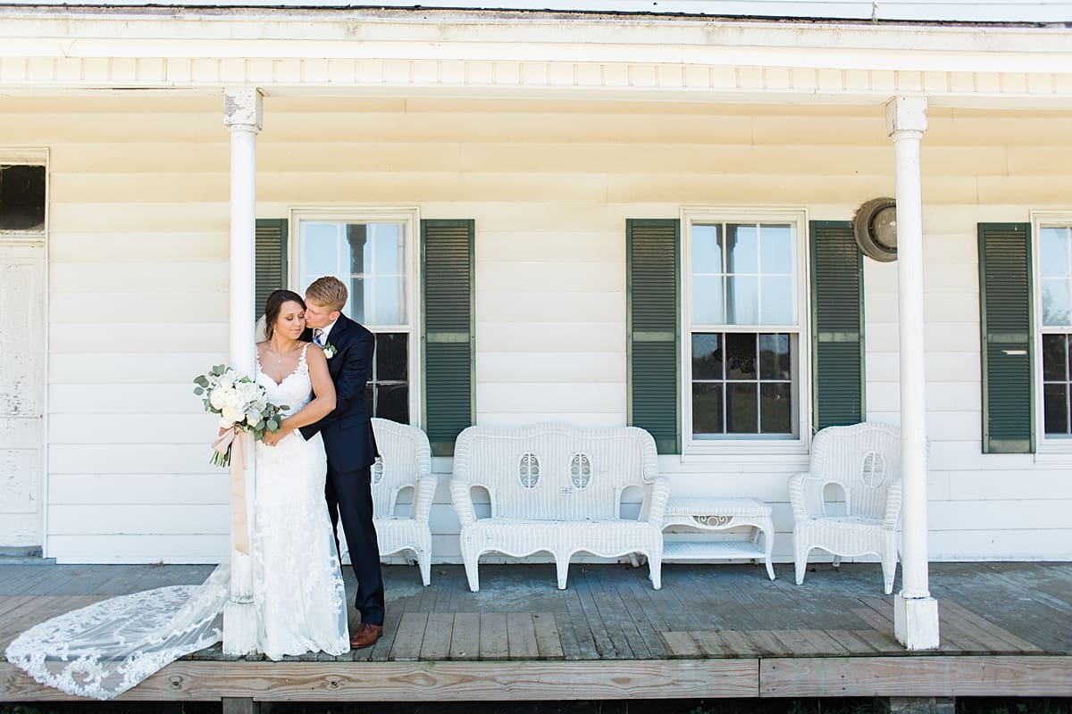 Arielle Peters Photography | Bride and groom kissing on historic front porch on wedding day at St. Joe Farm in Granger, Indiana.