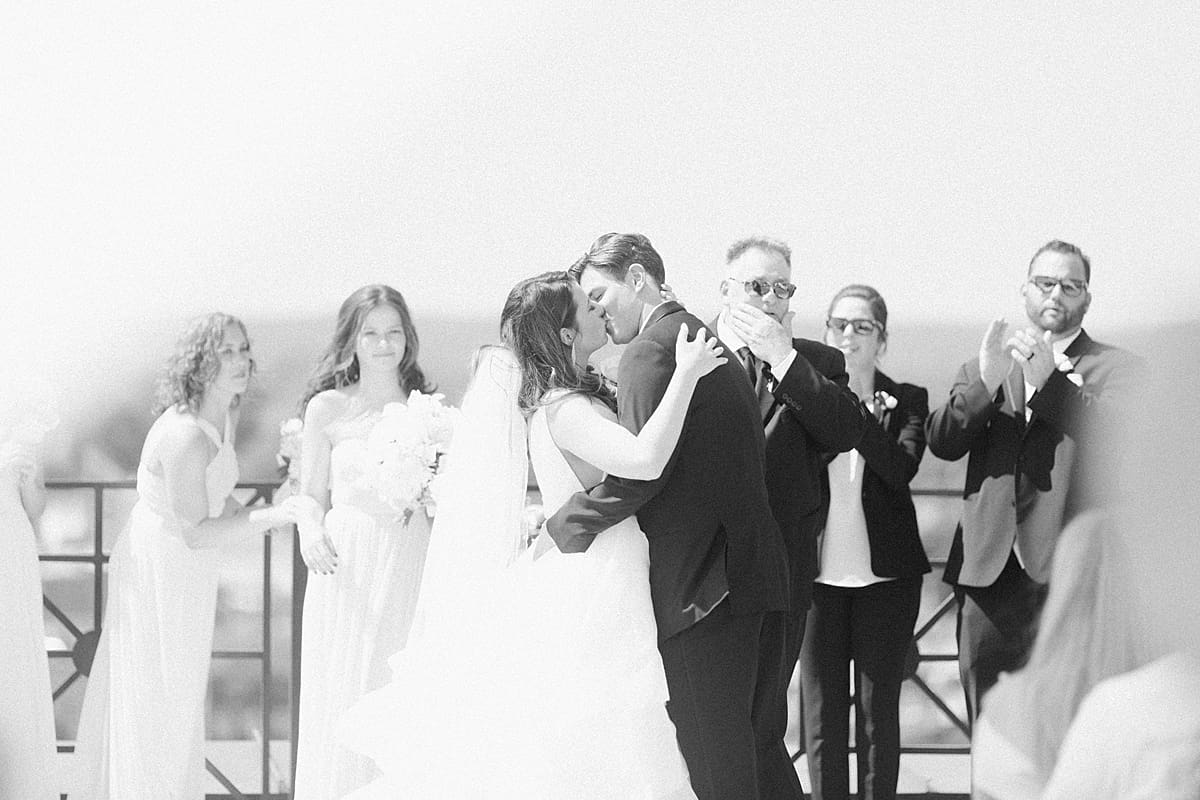 Arielle Peters Photography | Bride and groom kissing at alter on rooftop on wedding day at Loft 310 in Kalamazoo, Michigan.