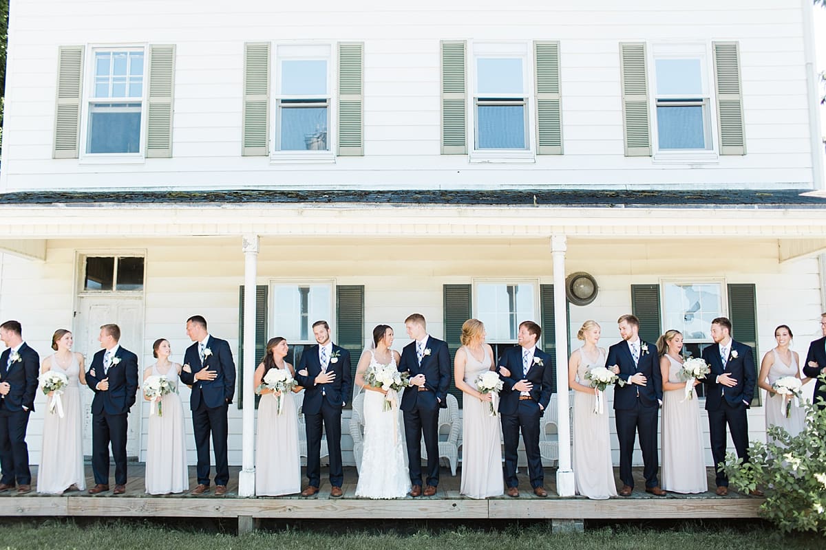 Arielle Peters Photography | Wedding party standing on historic front porch on wedding day at St. Joe Farm in Granger, Indiana.