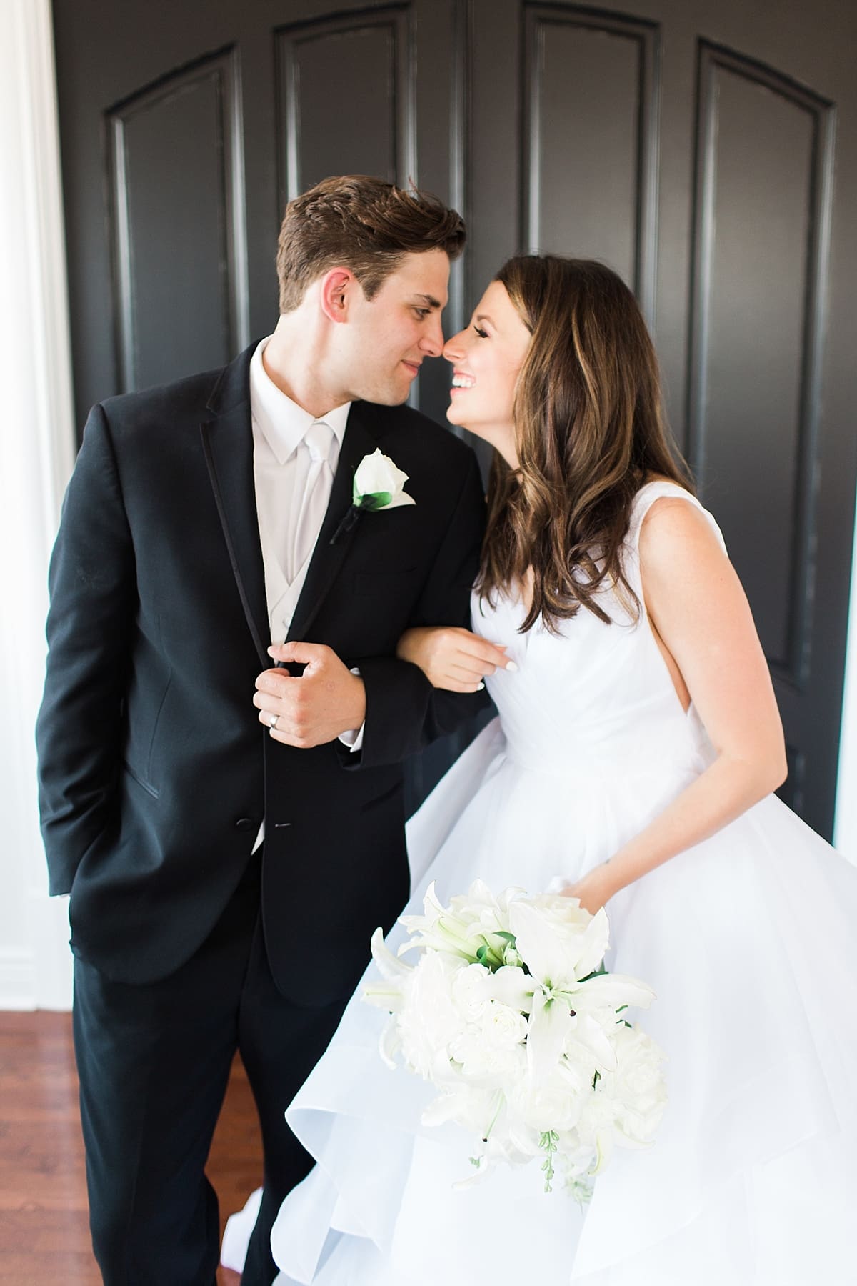 Arielle Peters Photography | Bride and groom in front of french doors on wedding day at Loft 310 in Kalamazoo, Michigan.