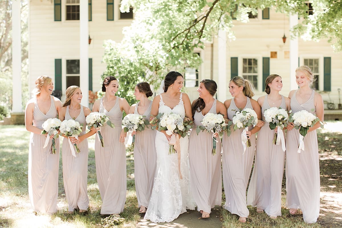 Arielle Peters Photography | Bride and bridesmaids walking on historic farm on wedding day at St. Joe Farm in Granger, Indiana.