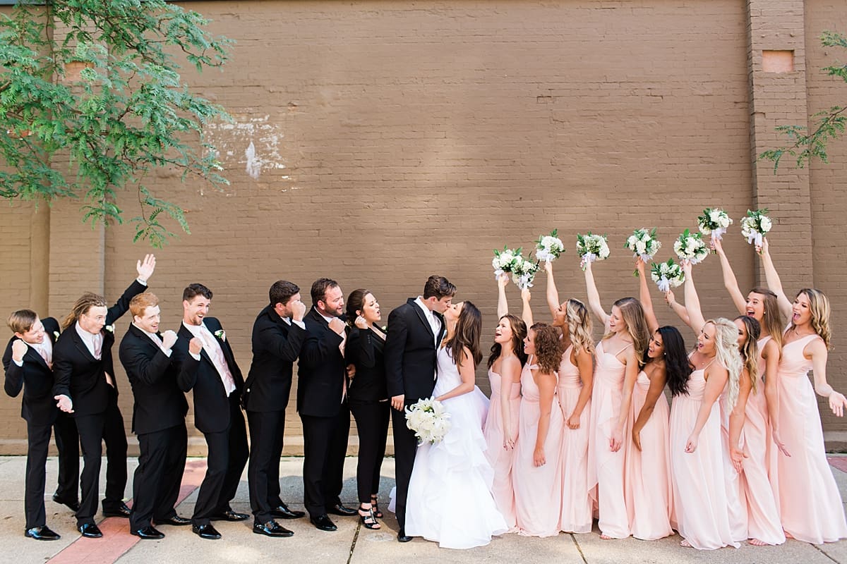 Arielle Peters Photography | Wedding party cheering on city streets on wedding day at Loft 310 in Kalamazoo, Michigan.