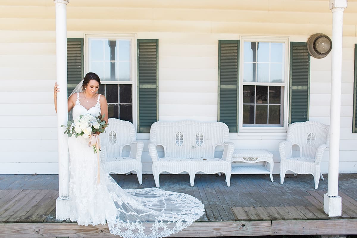 Arielle Peters Photography | Bride standing on historic front porch on wedding day at St. Joe Farm in Granger, Indiana.
