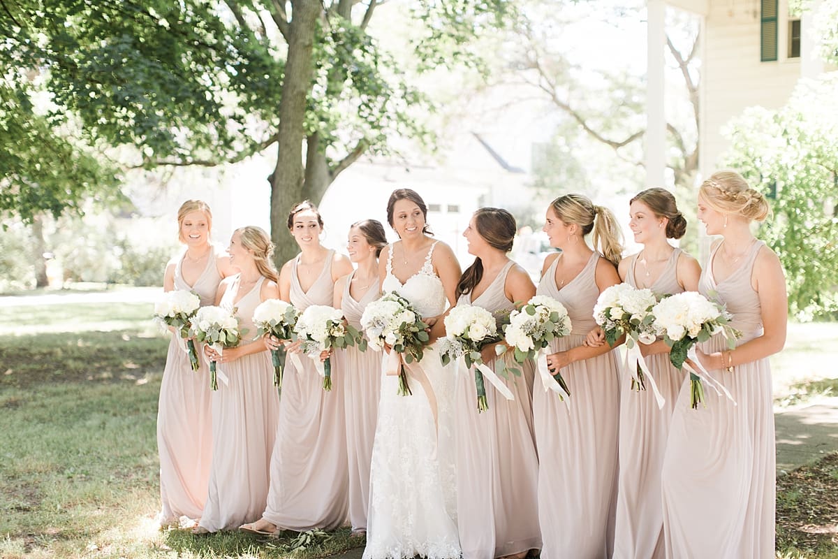 Arielle Peters Photography | Bride and bridesmaids walking on historic farm on wedding day at St. Joe Farm in Granger, Indiana.