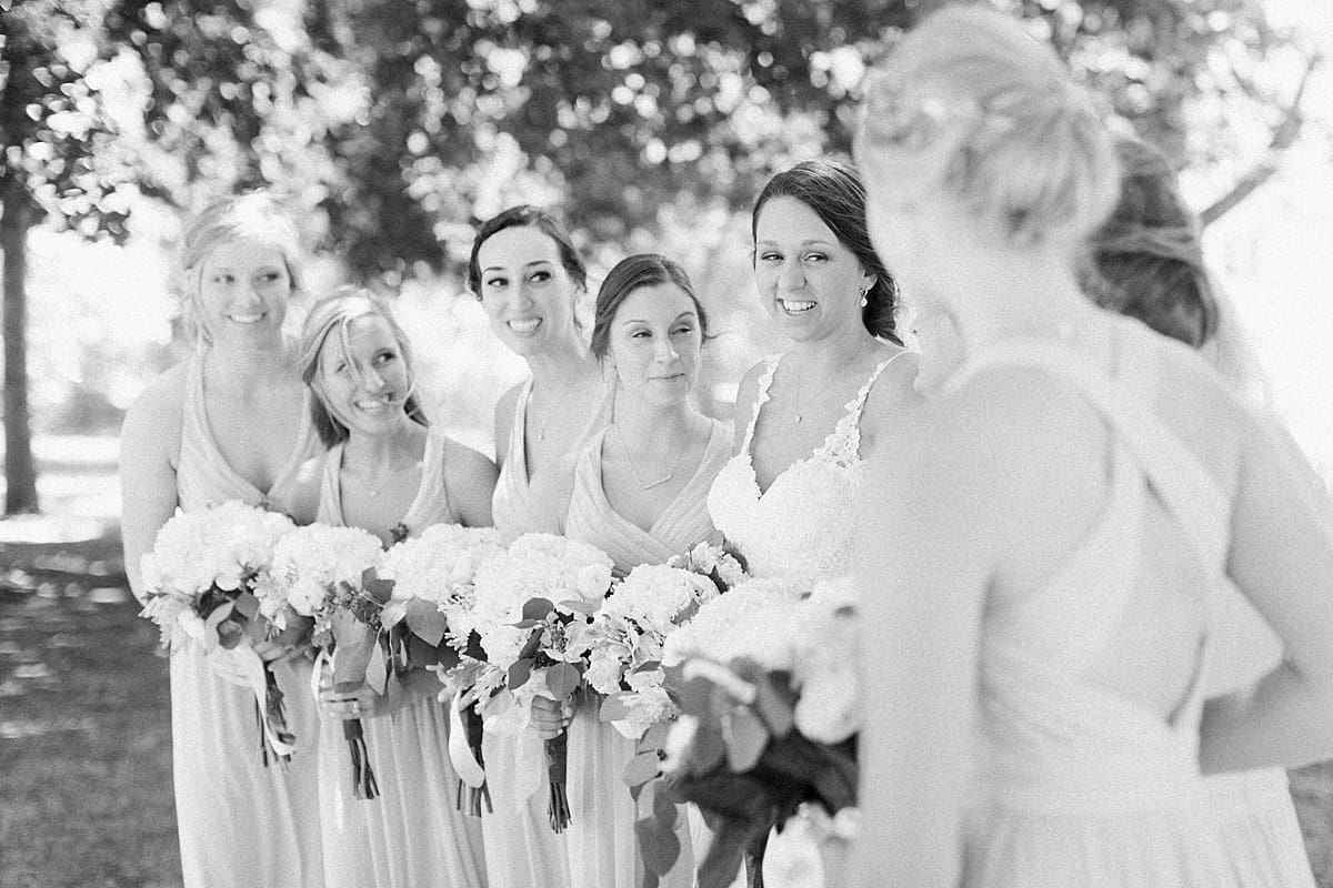 Arielle Peters Photography | Bride and bridesmaids walking on historic farm on wedding day at St. Joe Farm in Granger, Indiana.