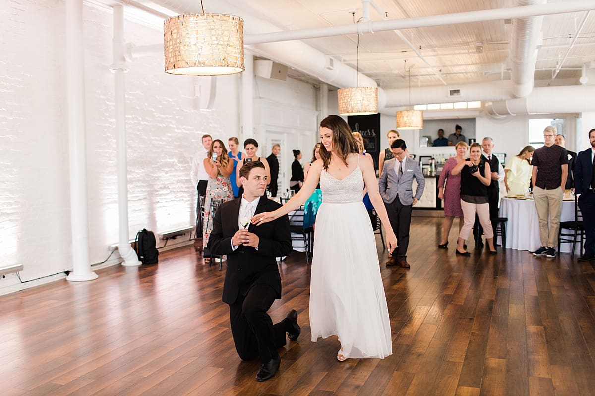 Arielle Peters Photography | Bride and groom entering wedding reception on wedding day at Loft 310 in Kalamazoo, Michigan.