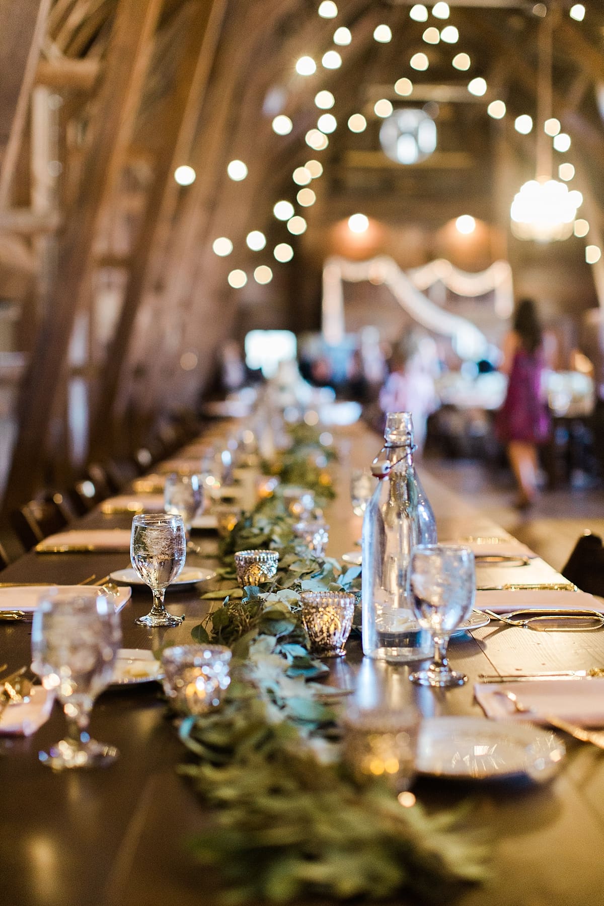 Arielle Peters Photography | Wedding reception table settings and floral arrangements inside historic barn on wedding day at St. Joe Farm in Granger, Indiana.