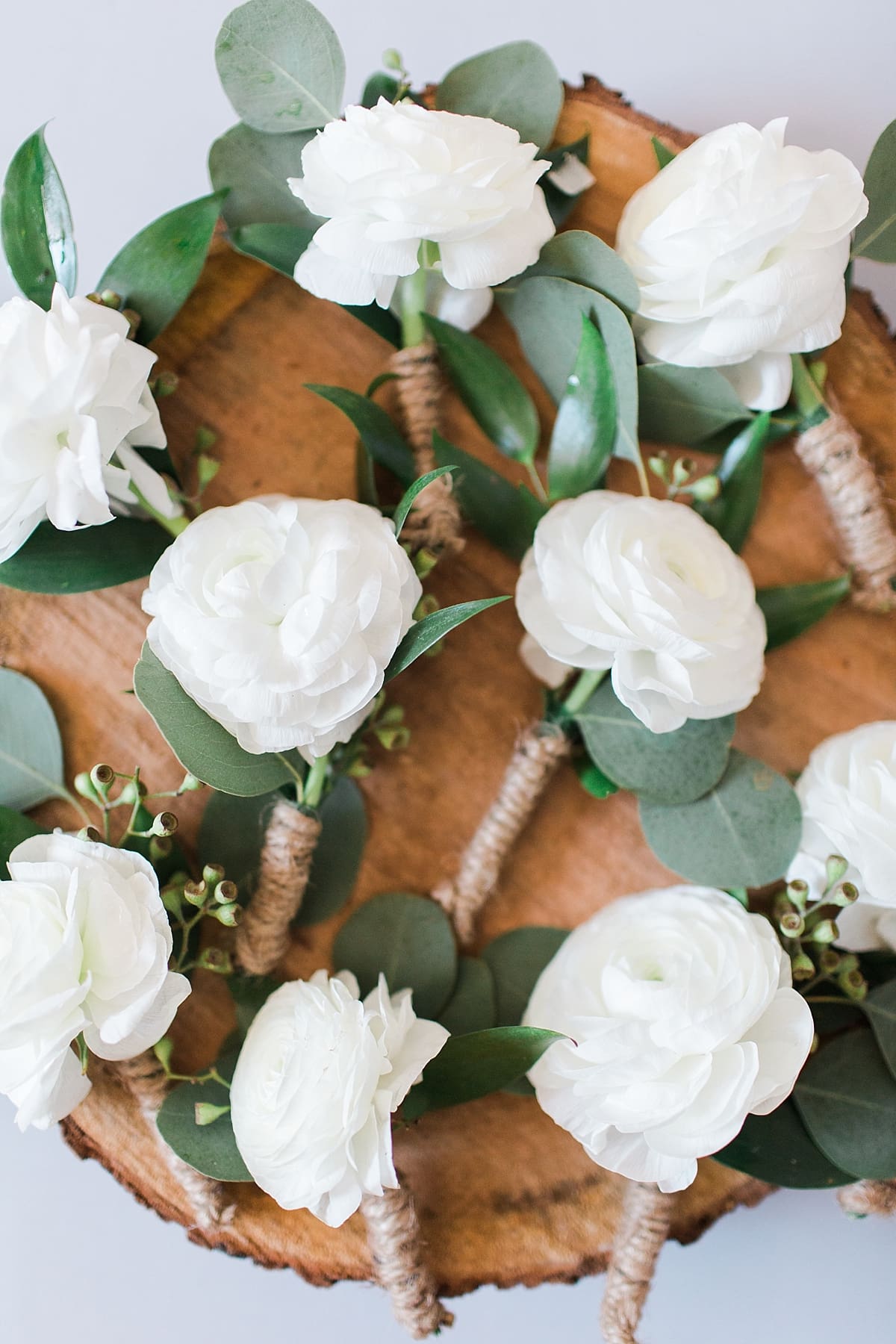 Arielle Peters Photography | Pile of boutonnieres on wedding day at St. Joe Farm in Granger, Indiana.