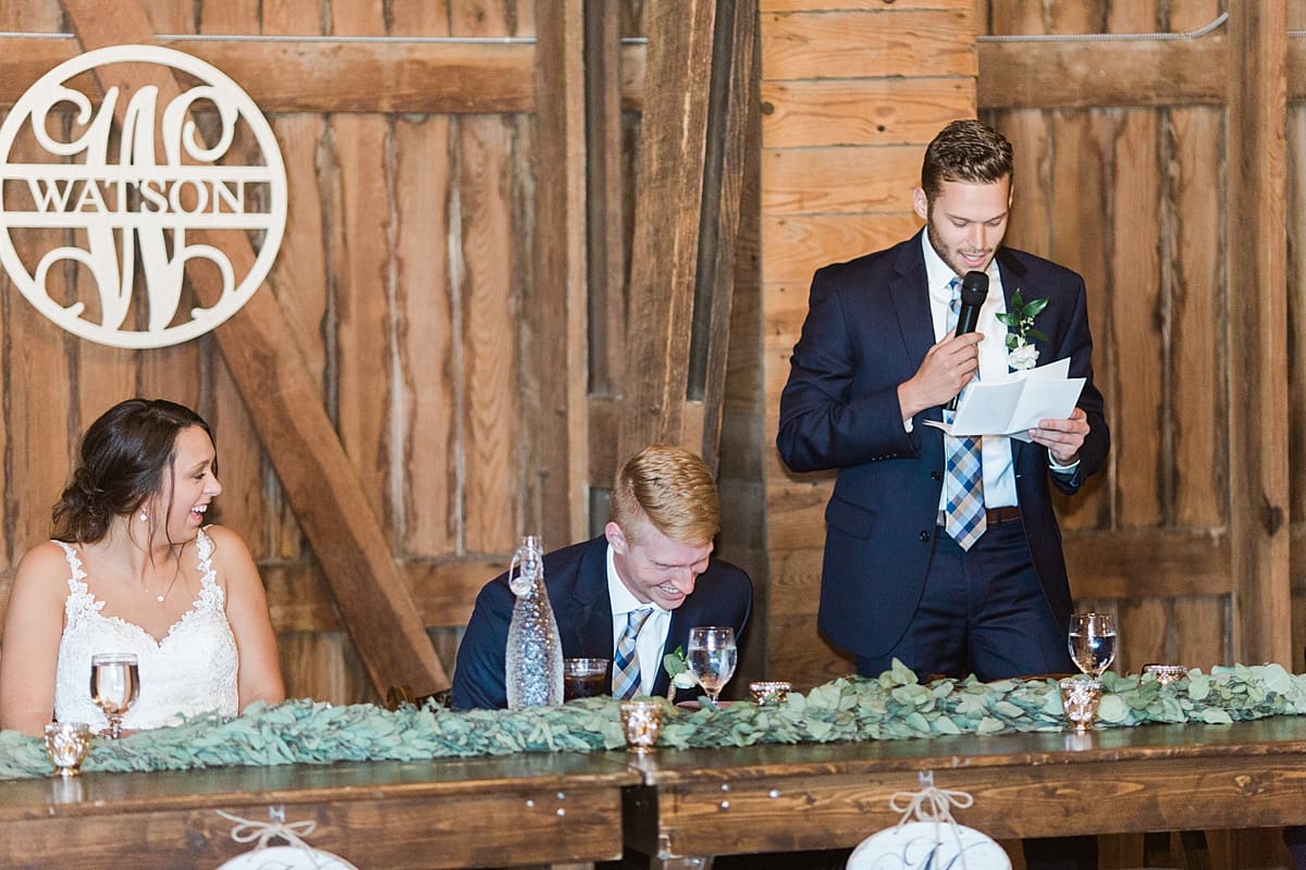 Arielle Peters Photography | Best man giving a speech at wedding reception inside historic barn on wedding day at St. Joe Farm in Granger, Indiana.
