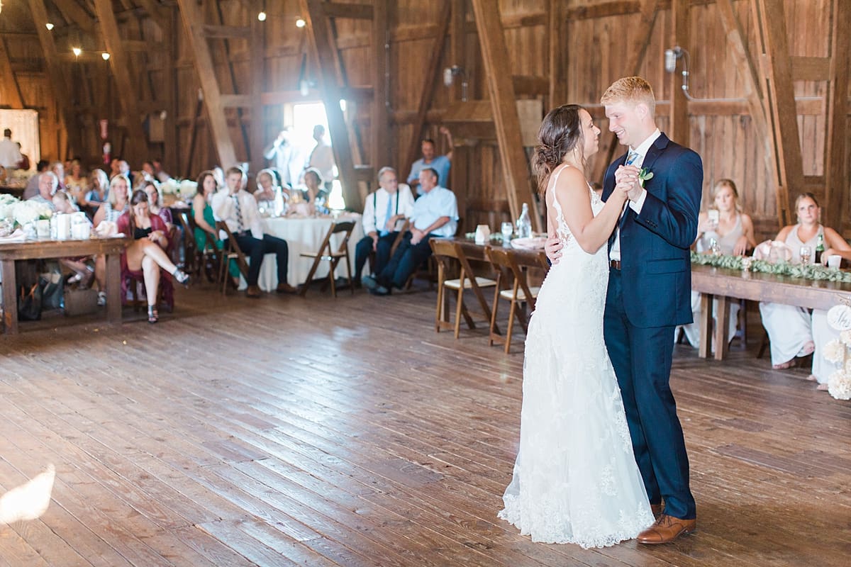 Arielle Peters Photography | Bride and groom sharing first dance inside historic barn on wedding day at St. Joe Farm in Granger, Indiana.