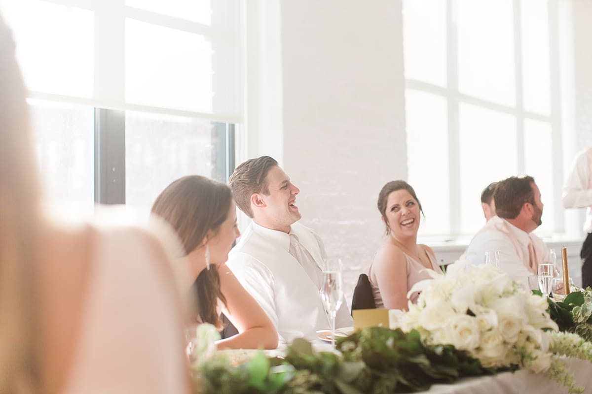 Arielle Peters Photography | Bride and groom laughing at wedding reception on wedding day at Loft 310 in Kalamazoo, Michigan.
