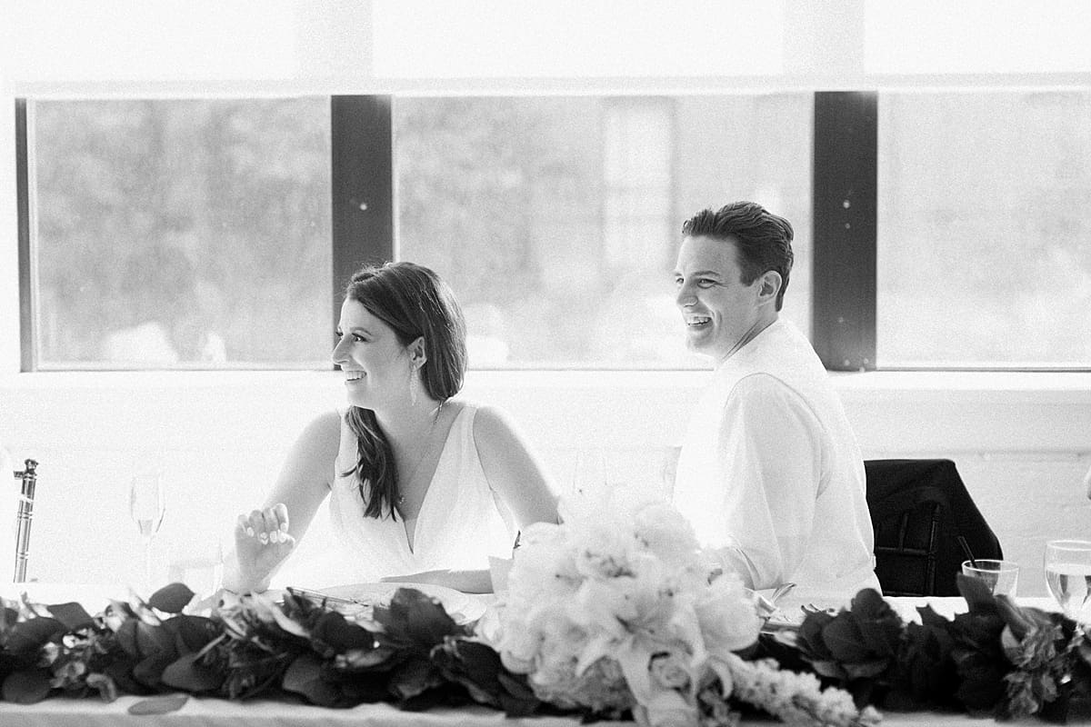Arielle Peters Photography | Bride and groom laughing at wedding reception on wedding day at Loft 310 in Kalamazoo, Michigan.