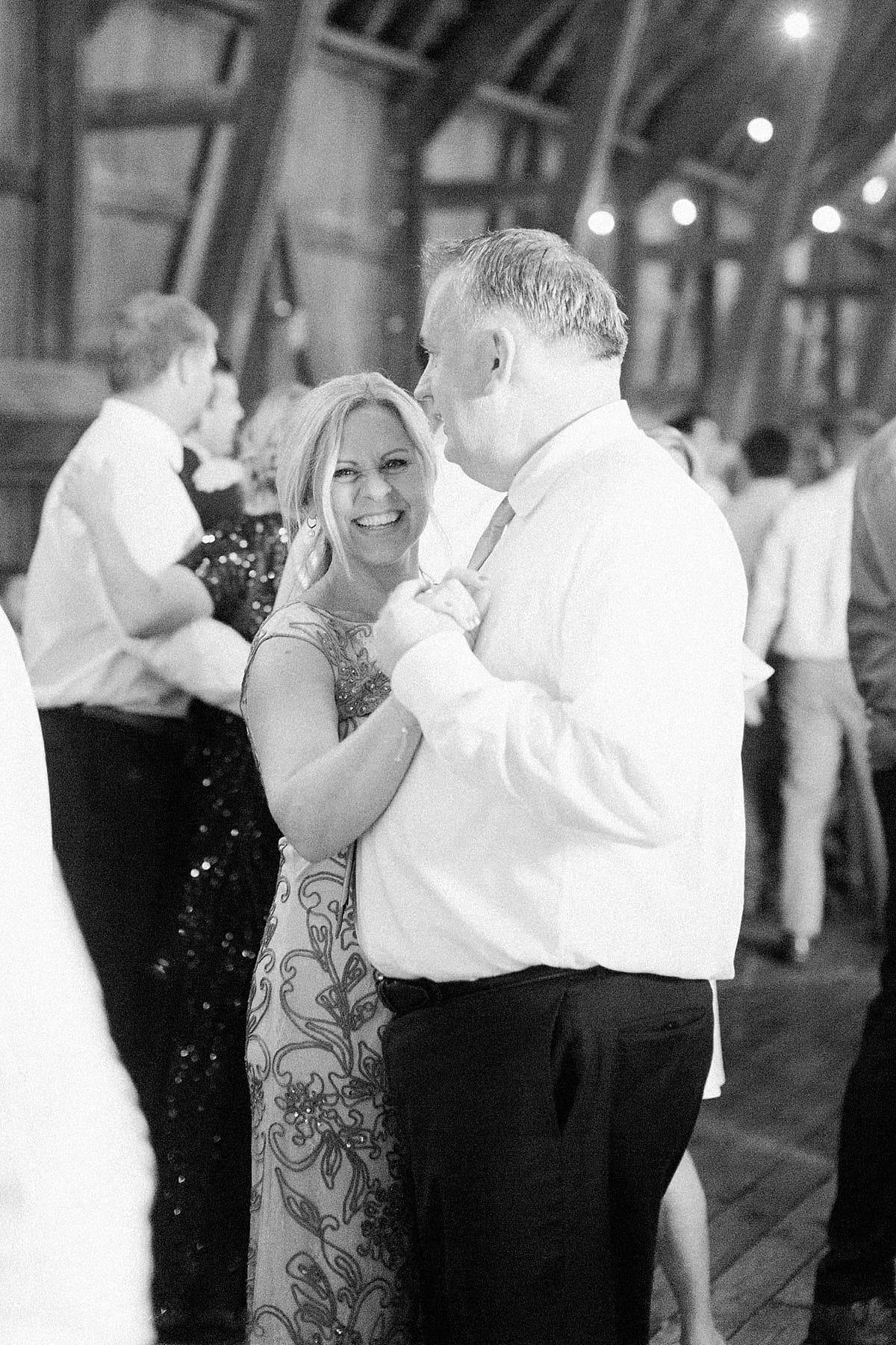 Arielle Peters Photography | Parents of the bride dancing inside historic barn on wedding day at St. Joe Farm in Granger, Indiana.