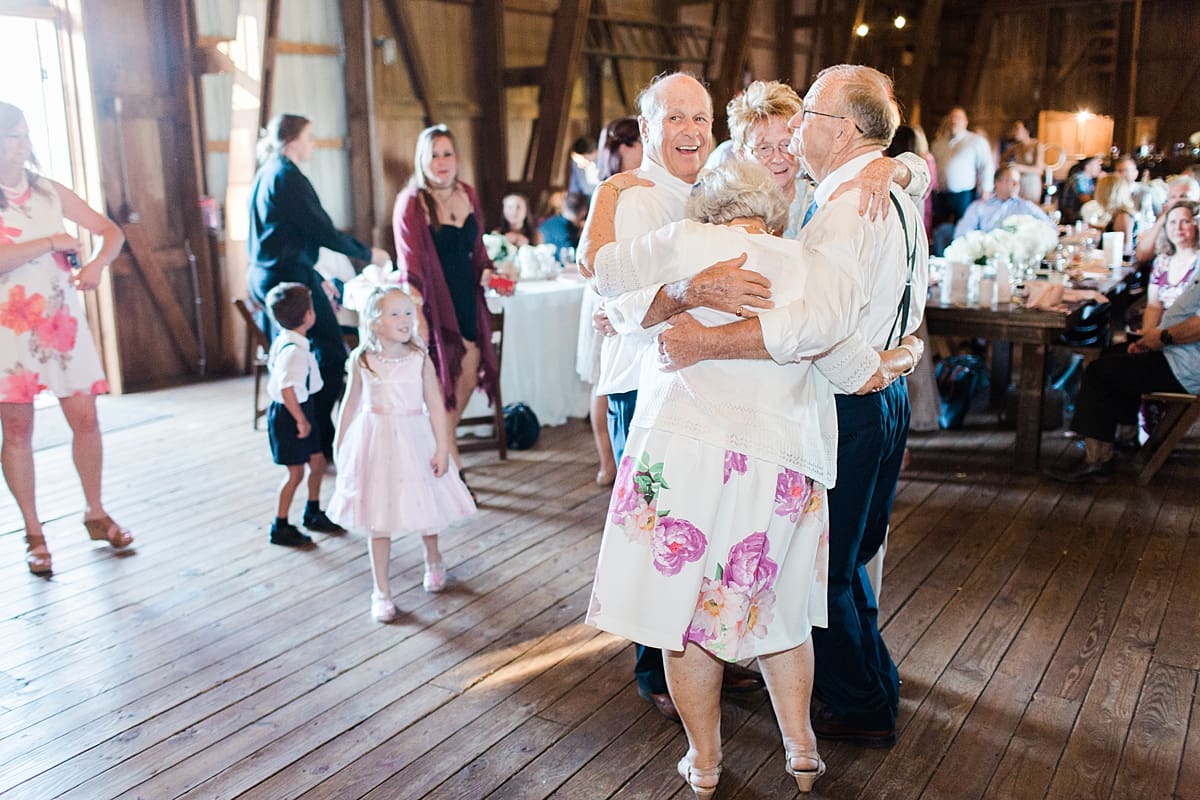 Arielle Peters Photography | Wedding guests dancing inside historic barn on wedding day at St. Joe Farm in Granger, Indiana.